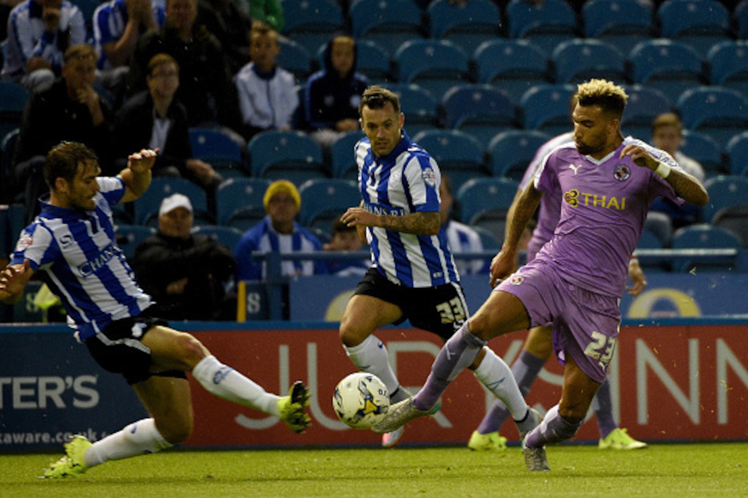 SHEFFIELD, ENGLAND - AUGUST 19:  Danny Williams of Reading is challenged by Rhoys Wiggins of Sheffield Wednesday during the Sky Bet Championship match between Sheffield Wednesday and Reading at Hillsborough Stadium on August 19, 2015 in Sheffield, England