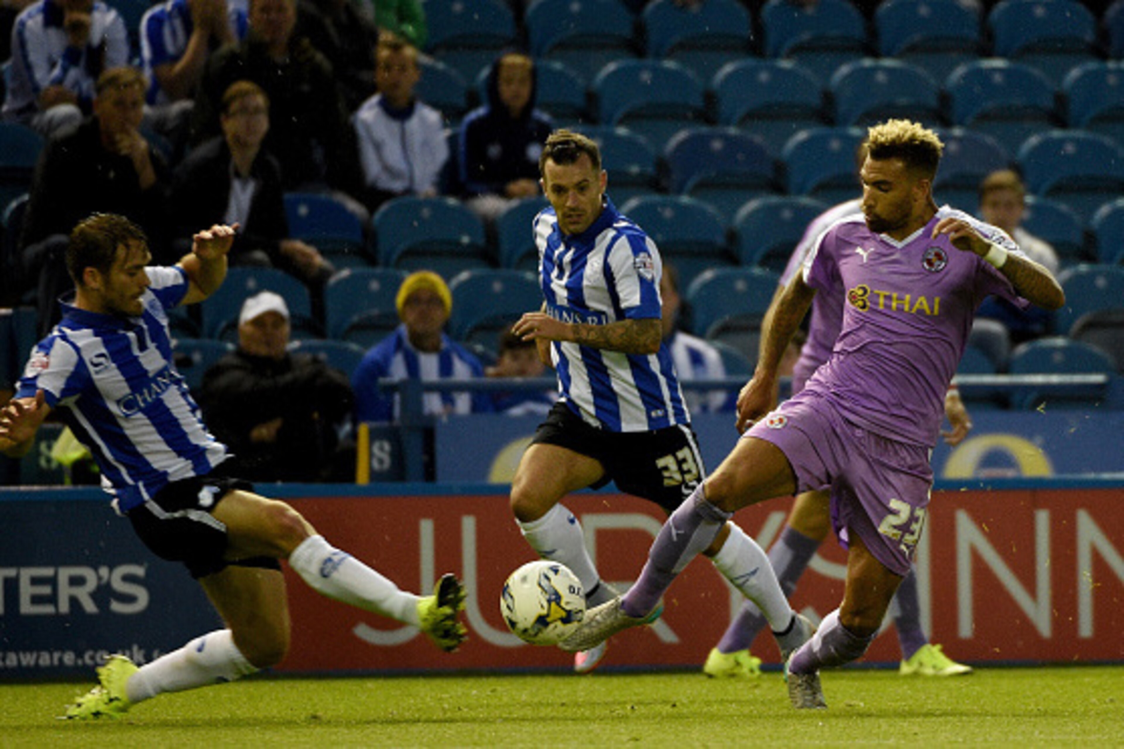 SHEFFIELD, ENGLAND - AUGUST 19:  Danny Williams of Reading is challenged by Rhoys Wiggins of Sheffield Wednesday during the Sky Bet Championship match between Sheffield Wednesday and Reading at Hillsborough Stadium on August 19, 2015 in Sheffield, England