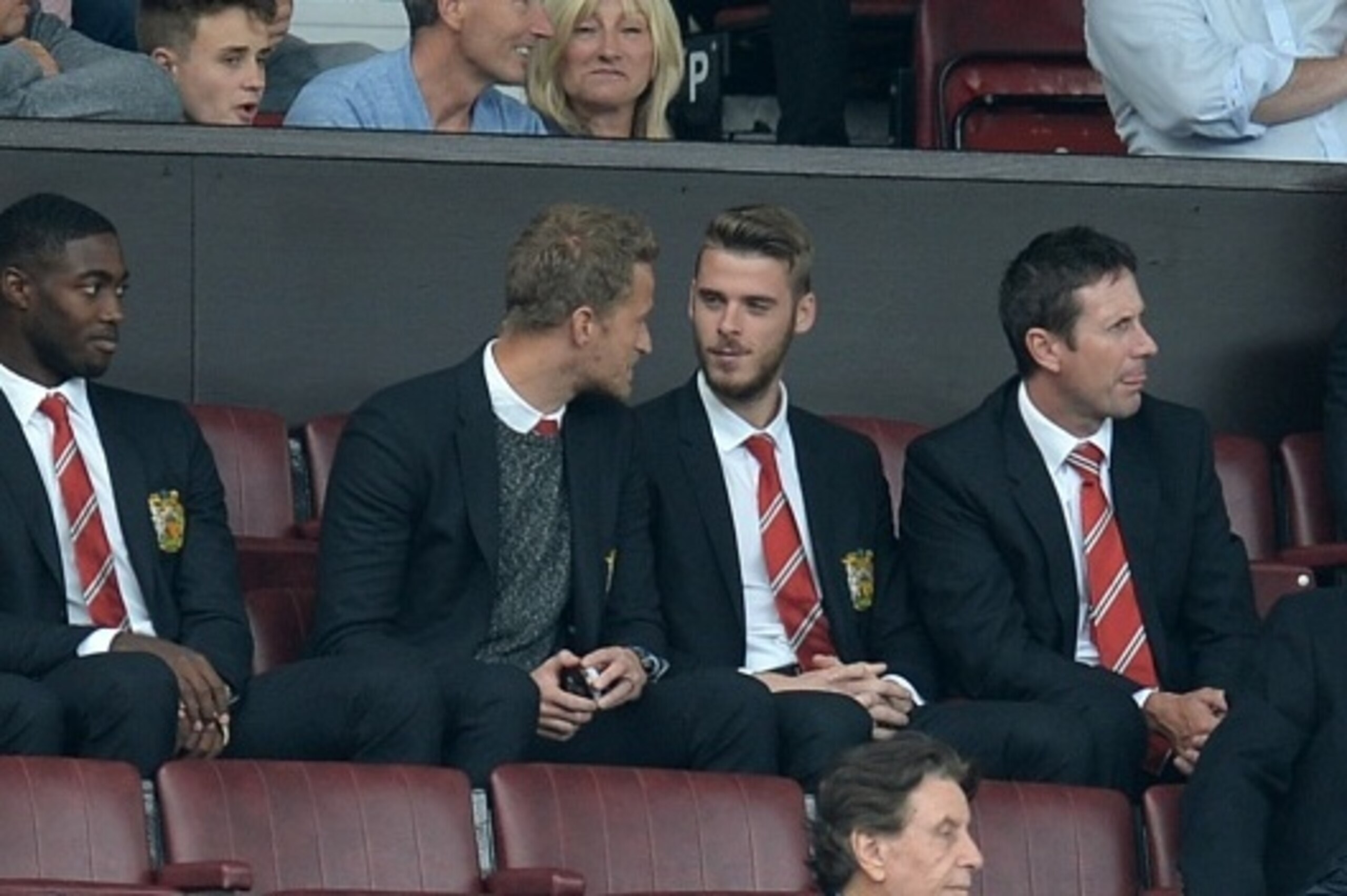 Manchester United's Spanish goalkeeper David de Gea (centre right) sits in the stands ahead of the English Premier League football match between Manchester United and Newcastle United at Old Trafford in Manchester, north west England, on August 22, 2015. 