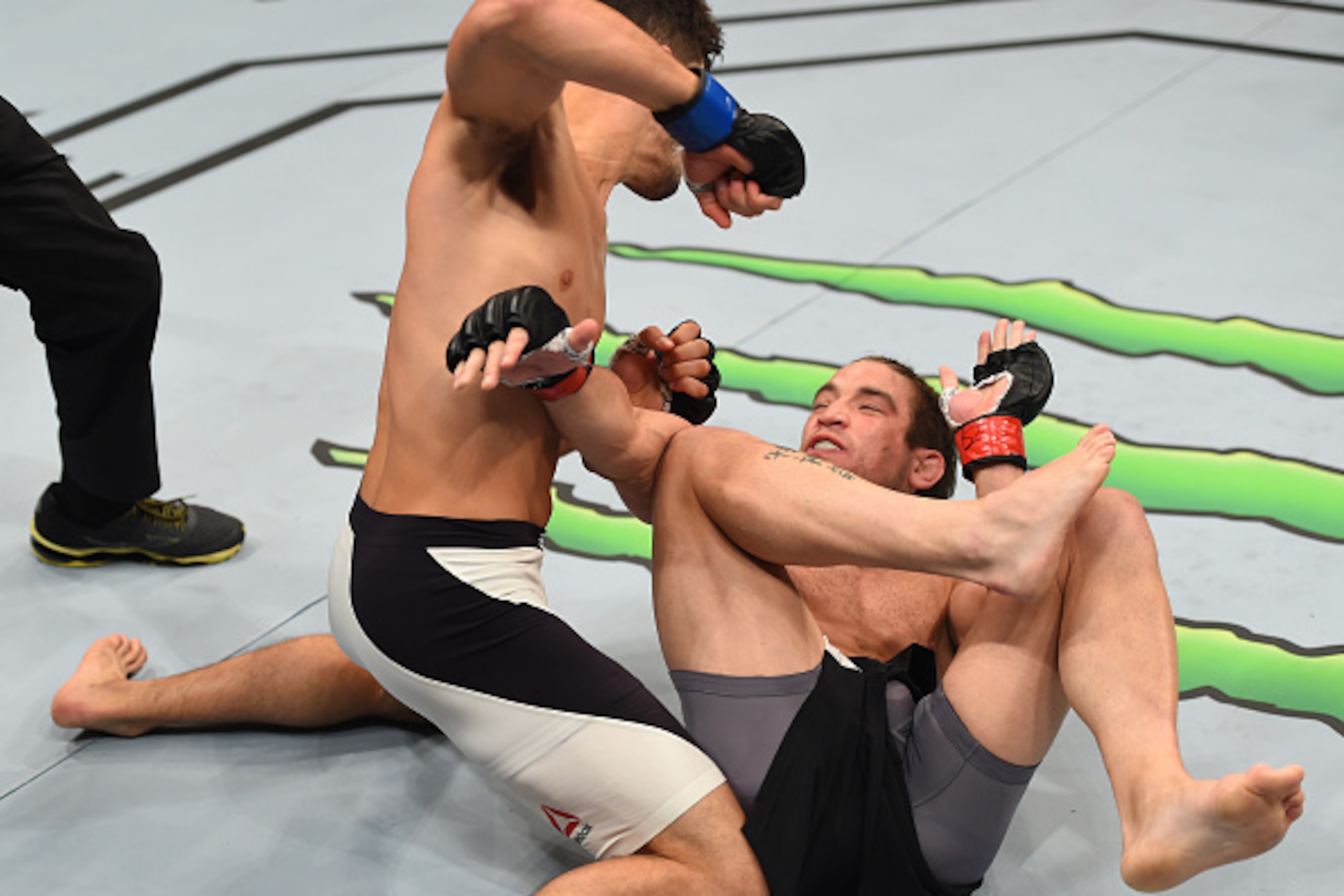 SASKATOON, SK - AUGUST 23:  (L-R) Frankie Perez of the United States punches Sam Stout in their lightweight bout during the UFC event at the SaskTel Centre on August 23, 2015 in Saskatoon, Saskatchewan, Canada. (Photo by Jeff Bottari/Zuffa LLC/Zuffa LLC v
