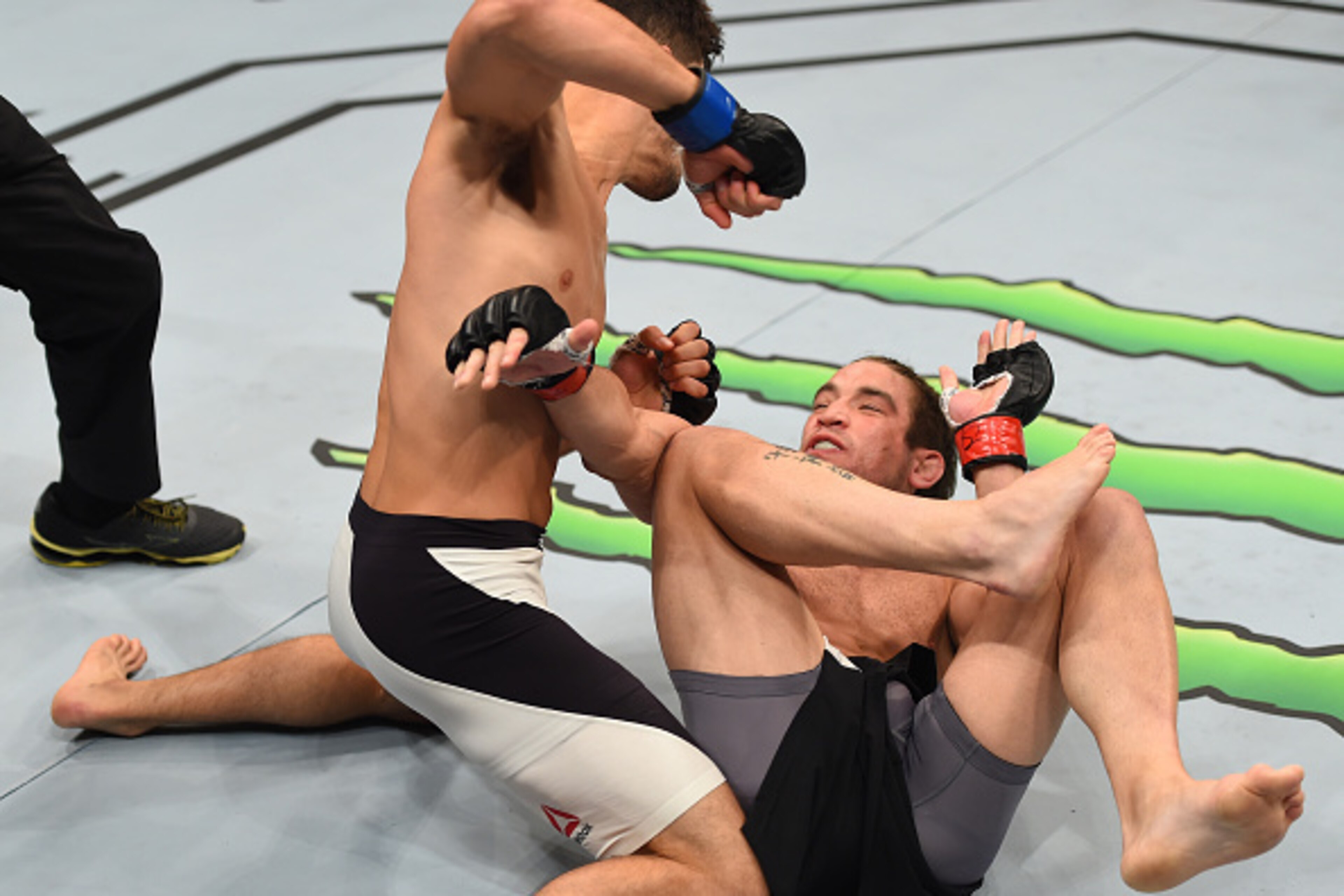SASKATOON, SK - AUGUST 23:  (L-R) Frankie Perez of the United States punches Sam Stout in their lightweight bout during the UFC event at the SaskTel Centre on August 23, 2015 in Saskatoon, Saskatchewan, Canada. (Photo by Jeff Bottari/Zuffa LLC/Zuffa LLC v