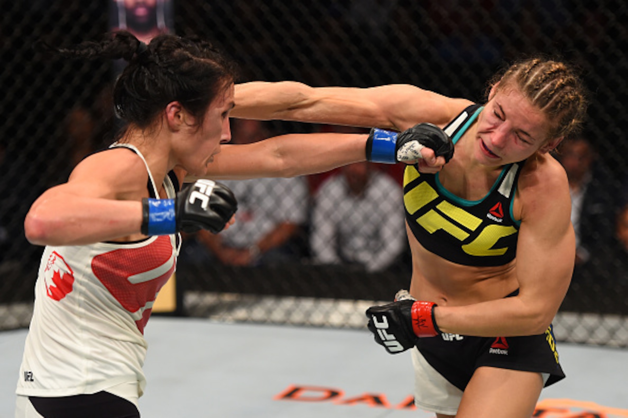 SASKATOON, SK - AUGUST 23:  (L-R) Valerie Letourneau punches Maryna Moroz of Ukraine in their women's strawweight bout during the UFC event at the SaskTel Centre on August 23, 2015 in Saskatoon, Saskatchewan, Canada. (Photo by Jeff Bottari/Zuffa LLC/Zuffa