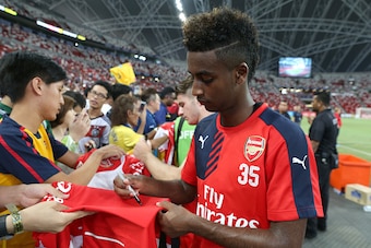 SINGAPORE - JULY 14:  Gedion Zelalem of Arsenal signs autographs for fans during the open Barclays Asia Trophy training session at the National Stadium on July 14, 2015 in Singapore.  (Photo by Lionel Ng/Getty Images)