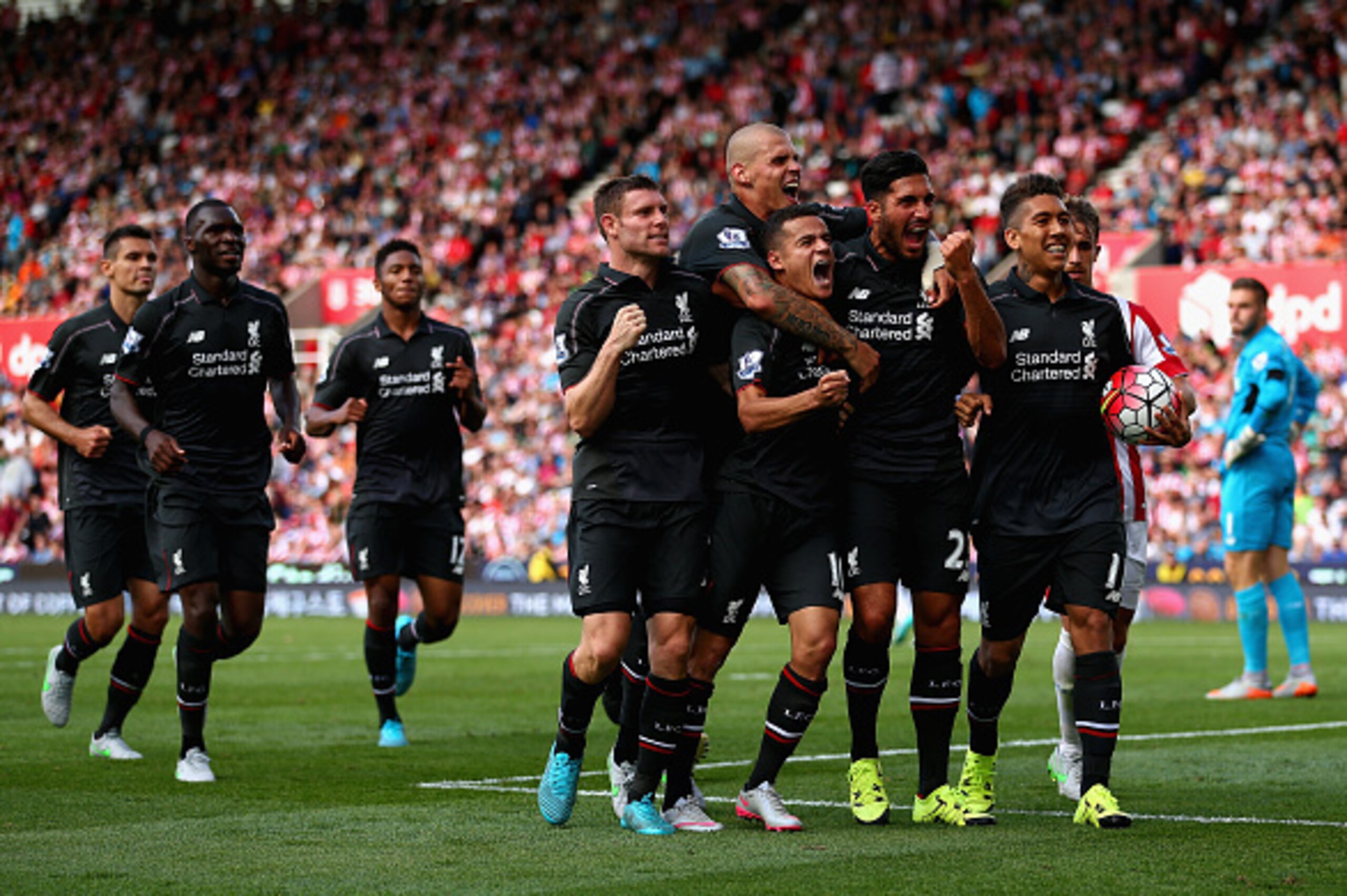 STOKE ON TRENT, ENGLAND - AUGUST 09: Philippe Coutino of Liverpool celebrates after scoring the winning goal with team mates Emre Can,Roberto Firmino and James Milner during the Barclays Premier League match between Stoke City and Liverpool at Britannia STOKE ON TRENT, ENGLAND - AUGUST 09: Philippe Coutino of Liverpool celebrates after scoring the winning goal with team mates Emre Can,Roberto Firmino and James Milner during the Barclays Premier League match between Stoke City and Liverpool at Britannia