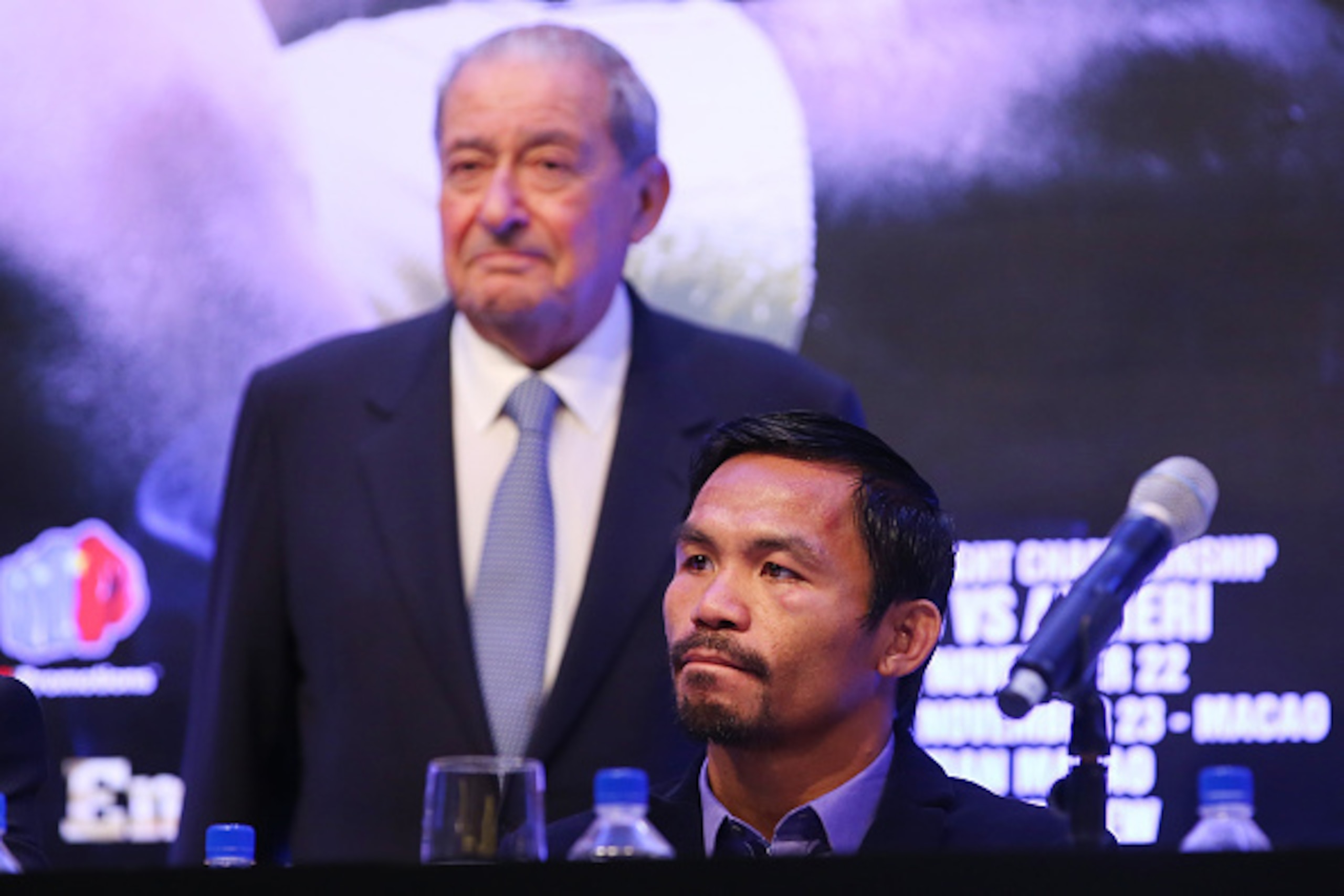 MACAU - NOVEMBER 23:  Manny Pacquiao of the Philippines and Top Rank CEO Bob Arum speak to media at the post fight press conference after winning against Chris Algieri of the United States during the WBO world welterweight title at The Venetian on Novembe