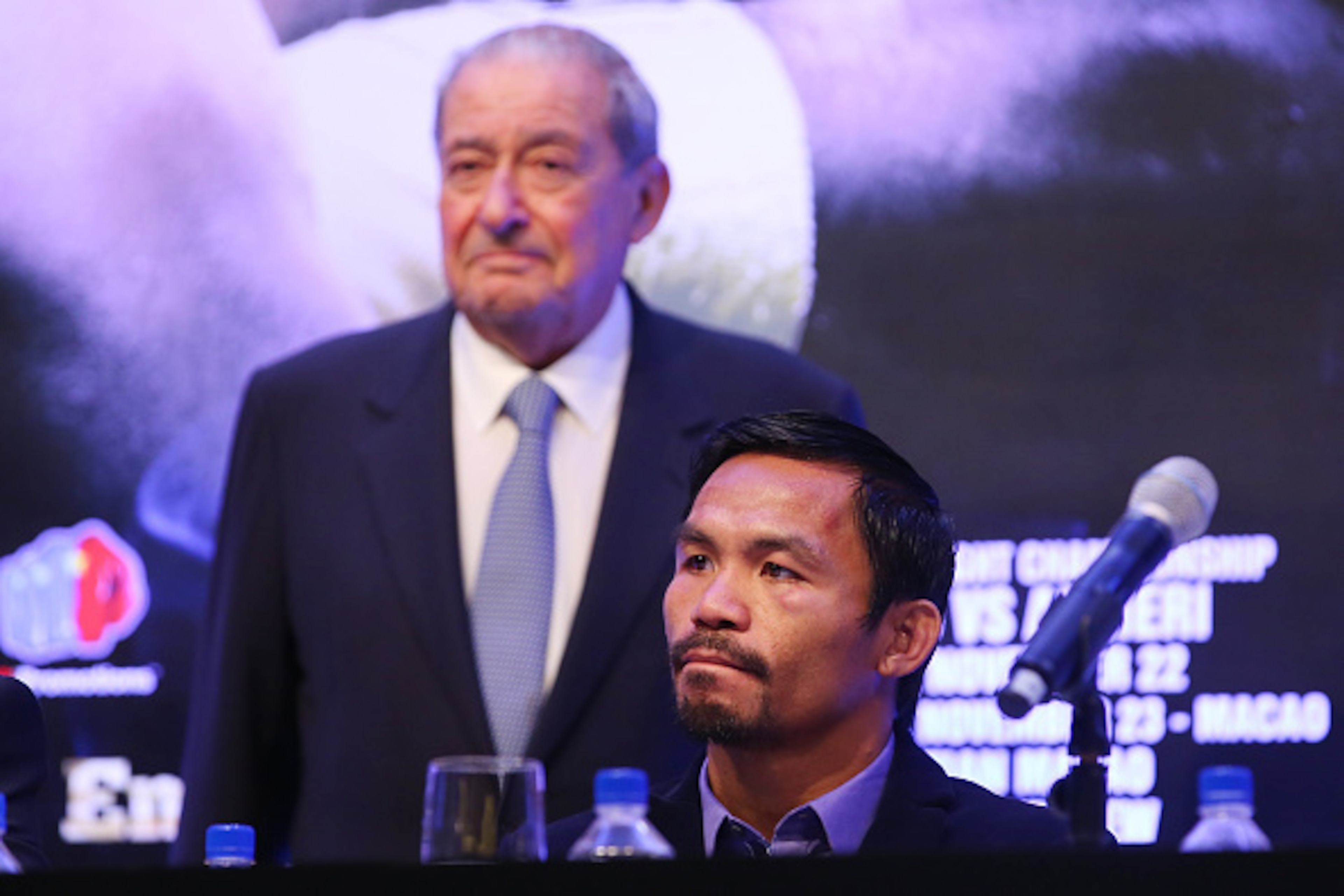 MACAU - NOVEMBER 23:  Manny Pacquiao of the Philippines and Top Rank CEO Bob Arum speak to media at the post fight press conference after winning against Chris Algieri of the United States during the WBO world welterweight title at The Venetian on Novembe