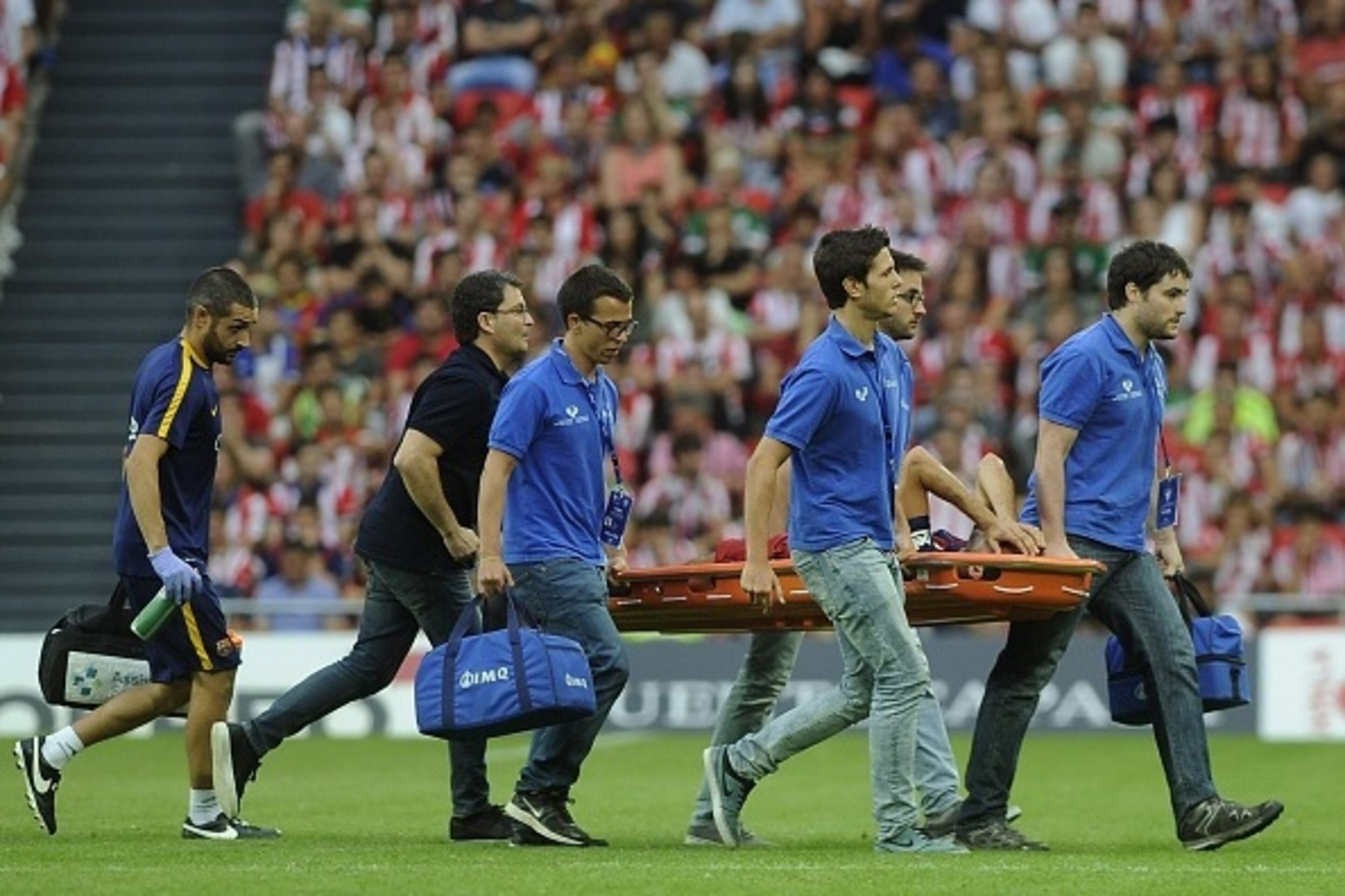 Barcelona's midfielder Sergio Busquets is stretched out during the Spanish league football match Athletic Club Bilbao vs FC Barcelona at the San Mames stadium in Bilbao on August 23, 2015.  AFP PHOTO/ ANDER GILLENEA        (Photo credit should read ANDER 