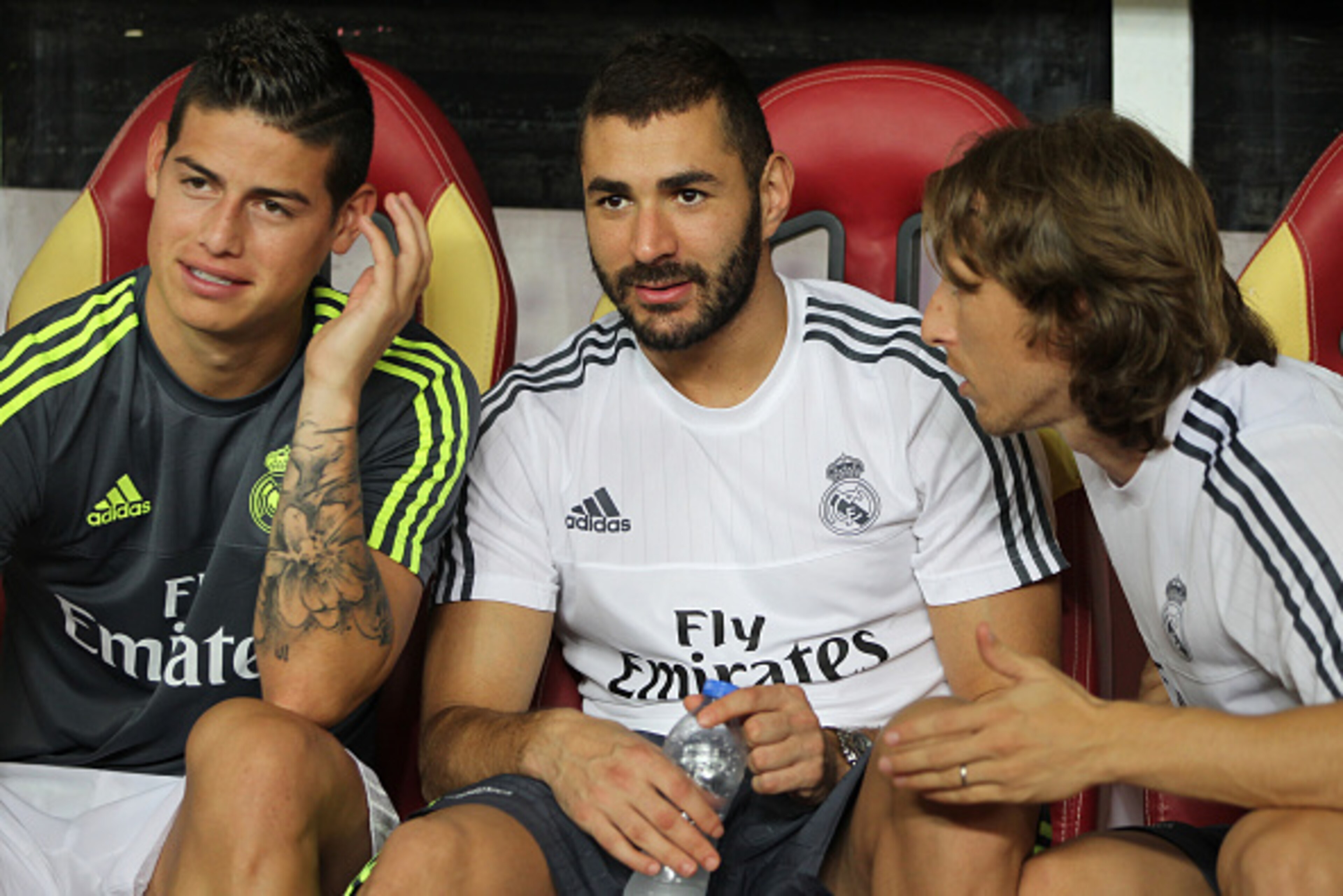 GUANGZHOU, CHINA - JULY 27: James Rodriguez, Benzema and Luka Modric of Real Madrid talk on the bench during the match of International Champions Cup China 2015 between Real Madrid and FC Internazionale at Tianhe Stadium on July 27, 2015 in Guangzhou, Chi
