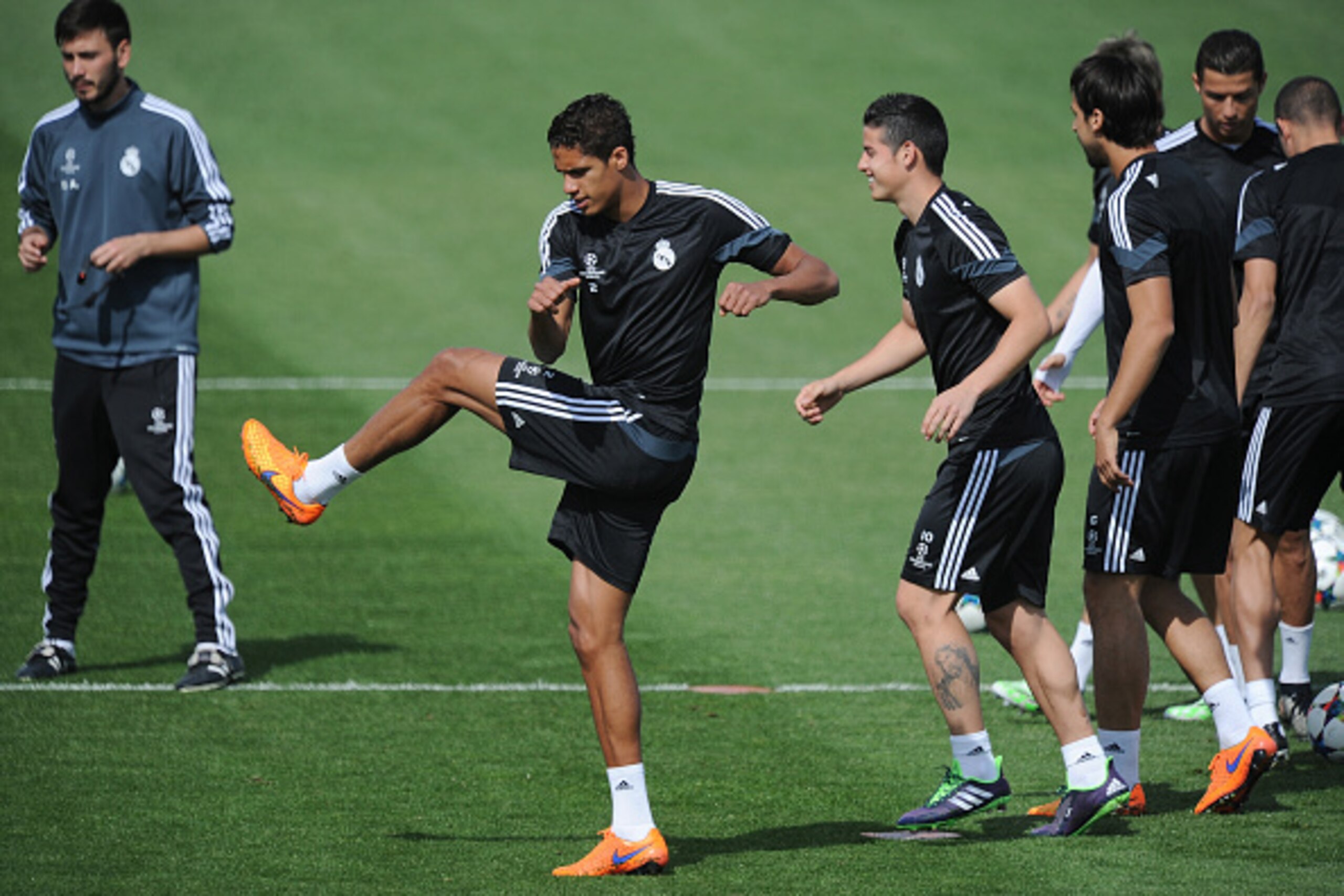 MADRID, SPAIN - APRIL 21:  Raphael Varane of Real Madrid warms up with James Rodriguez during the Real Madrid training at Valdebebas grounds ahead of the UEFA Champions League Quarter Final, Second Leg match on April 21, 2015 in Madrid, Spain.  (Photo by 