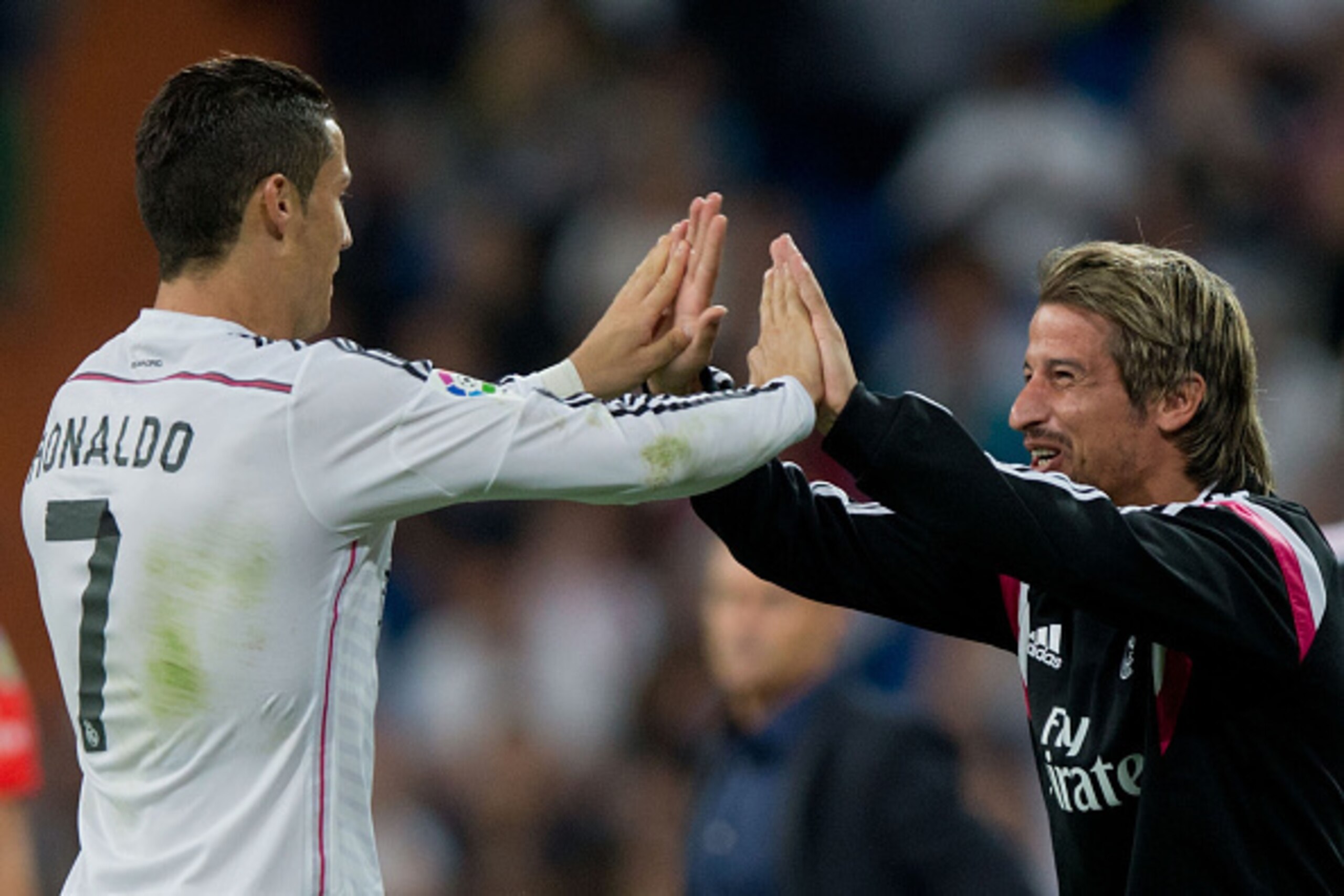 MADRID, SPAIN - SEPTEMBER 23:  Cristiano Ronaldo (L) of Real Madrid CF celebrates scoring their fourth goal with team mate Fabio Coentrao (R) from a penalty shot during the La Liga match between Real Madrid CF and Elche CF at Estadio Santiago Bernabeu on 