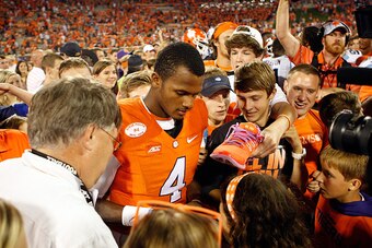 CLEMSON, SC - SEPTEMBER 27: Deshaun Watson #4 of the Clemson Tigers signs autographs with fans after the Tigers defeated the North Carolina Tar Heels 50-35 at Memorial Stadium on September 27, 2014 in Clemson, South Carolina. (Photo by Tyler Smith/Getty I