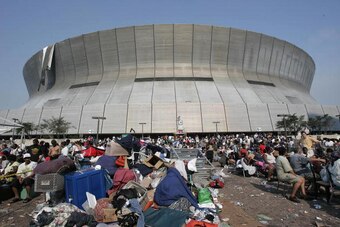 New Orleans, UNITED STATES:  Hurricane Katrina survivors wait outside the Superdome and Convetion Center in New Orleans 02 September, 2005. The New Orleans sports arena that housed hurricane refugees for five days in lawless squalor was finally emptied Fr