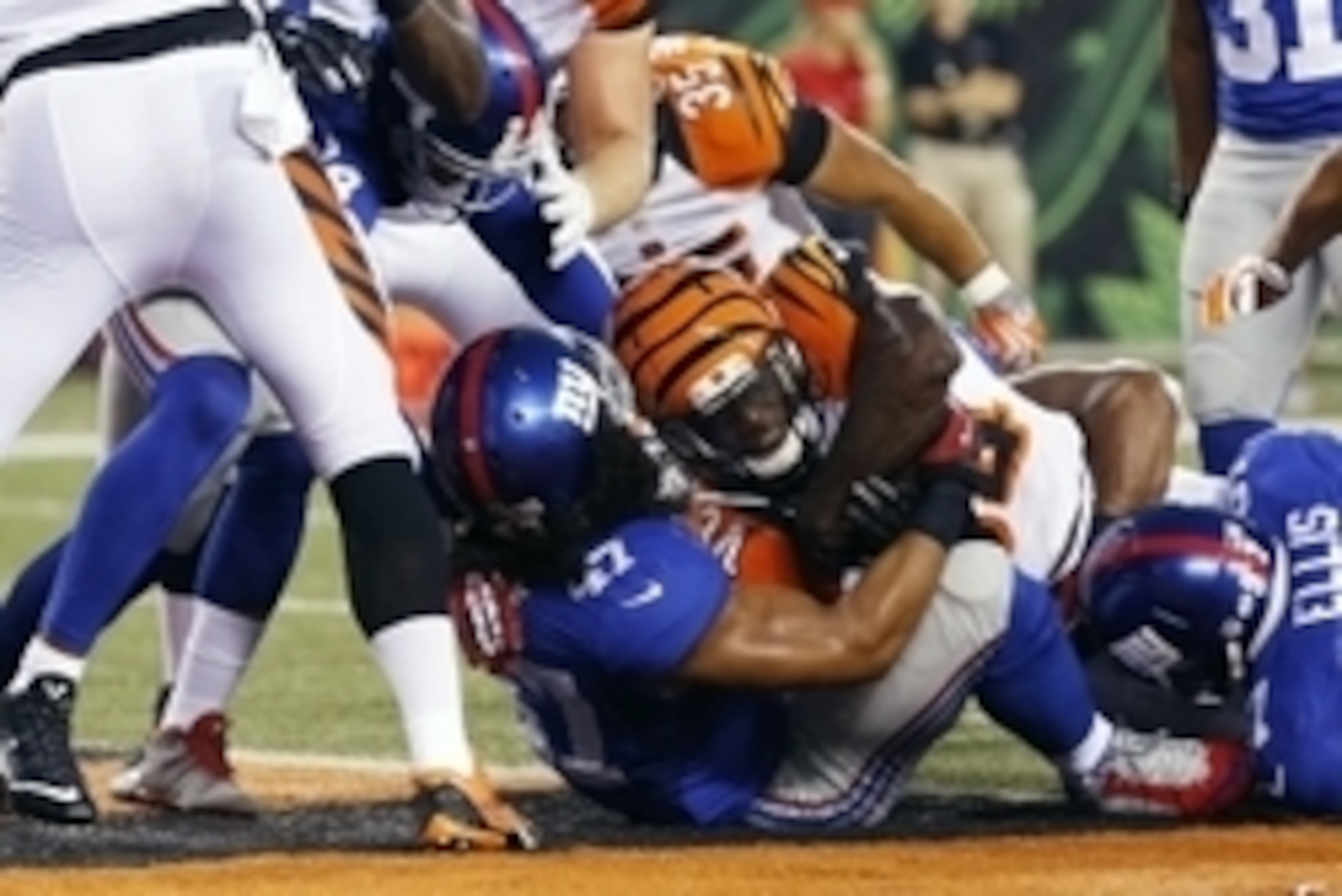 Aug 14, 2015; Cincinnati, OH, USA; Cincinnati Bengals running back James Jr. Wilder (34) scores a touchdown while being tackled by New York Giants linebacker Uani' Unga (47) in the first half in a preseason NFL football game at Paul Brown Stadium. Mandato