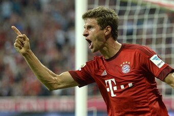 Bayern Munich's midfielder Thomas Mueller celebrates scoring the 3-0 goal during the German first division Bundesliga football match FC Bayern Munich vs Hamburger SV at the Allianz Arena in Munich, southern Germany, on August 14, 2015. The match is the fi