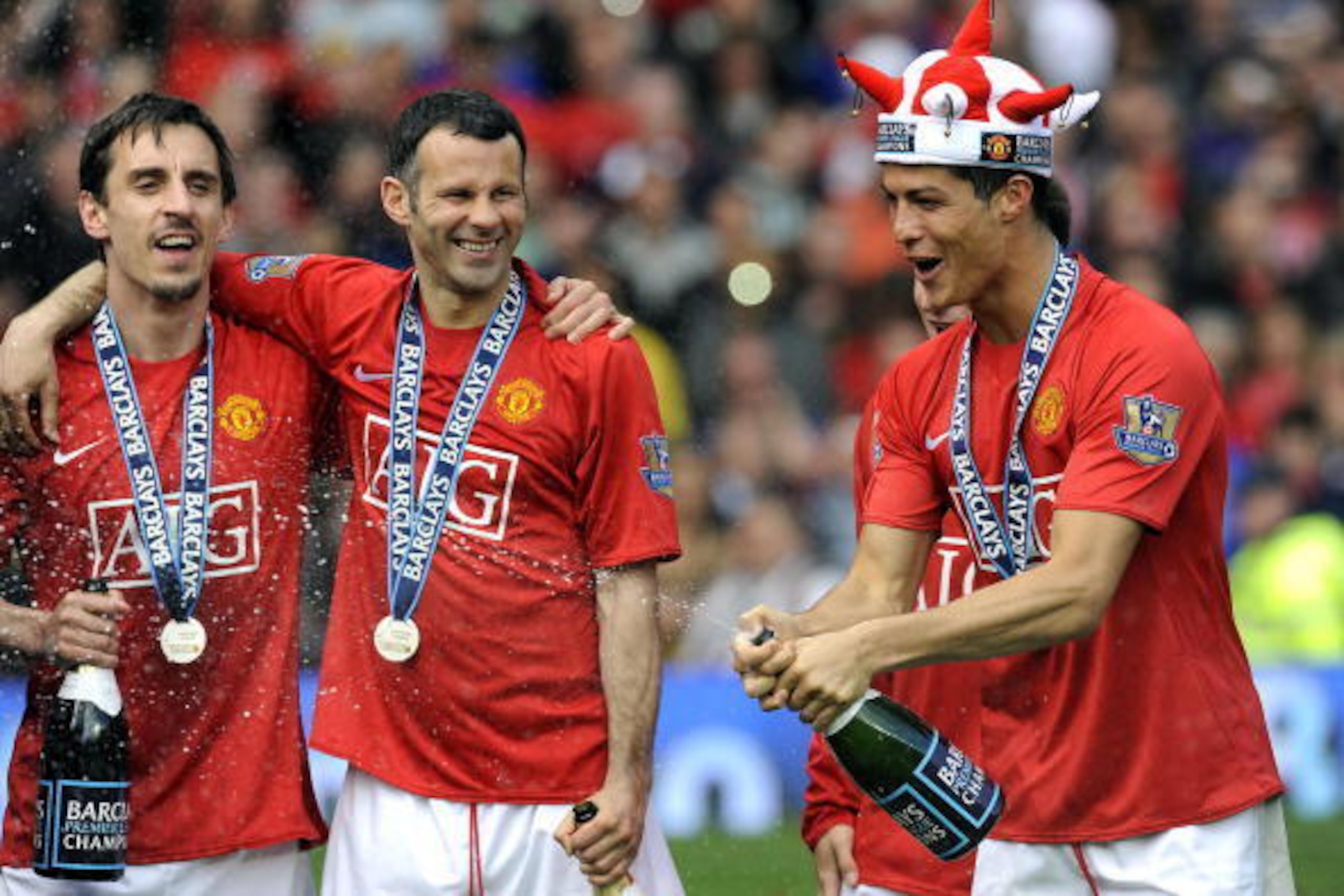 Manchester United's Portuguese midfielder Cristiano Ronaldo (R) celebrates with English defender Gary Neville (L) and Welsh midfielder Ryan Giggs after they clinch the title with a 0-0 draw against Arsenal in the English Premier League football match at O Manchester United's Portuguese midfielder Cristiano Ronaldo (R) celebrates with English defender Gary Neville (L) and Welsh midfielder Ryan Giggs after they clinch the title with a 0-0 draw against Arsenal in the English Premier League football match at O