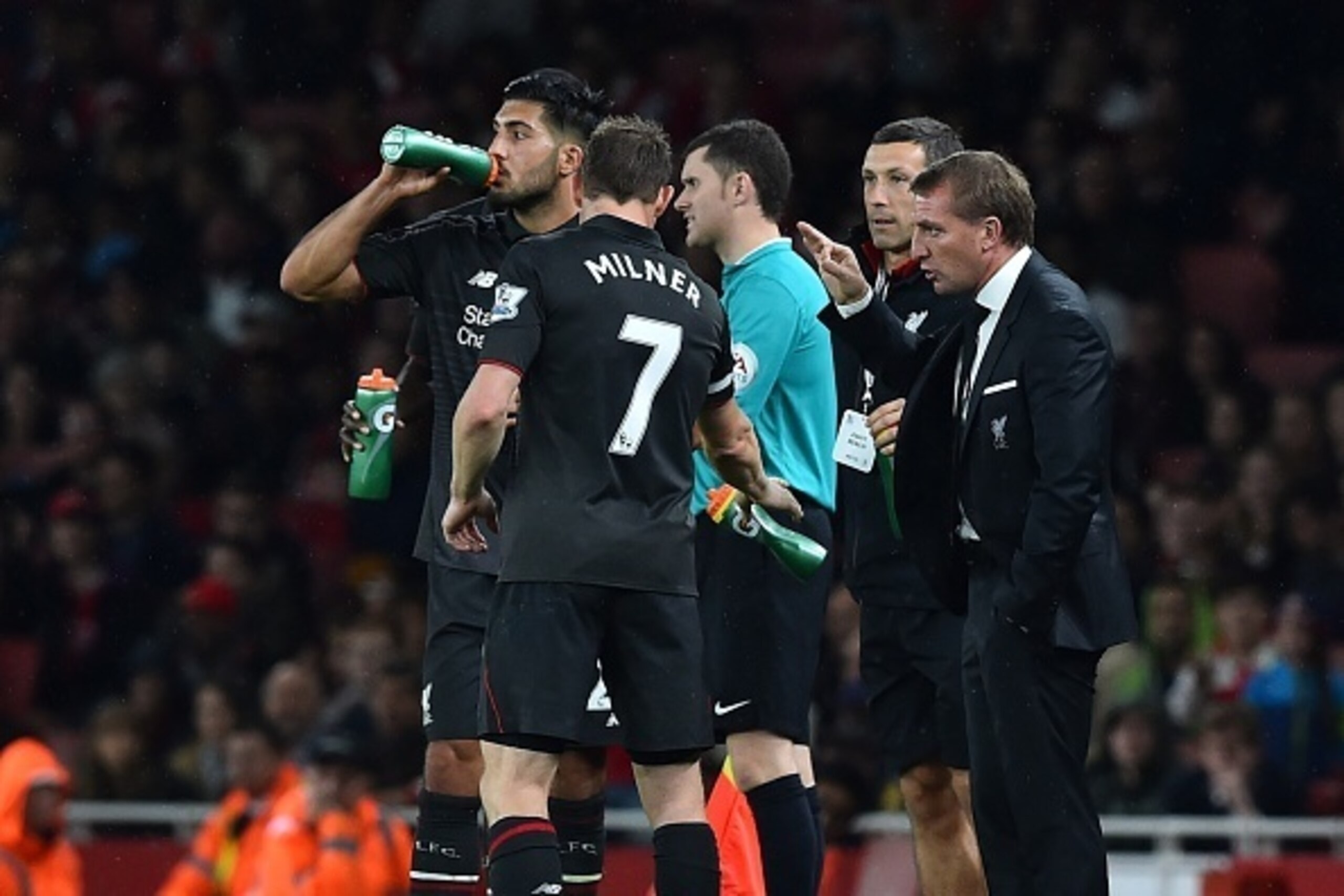 Liverpool's Northern Irish manager  Brendan Rodgers (R) speaks to Liverpool's English midfielder James Milner during the English Premier League football match between Arsenal and Liverpool at the Emirates stadium, north London on August 24, 2015. AFP PHOT