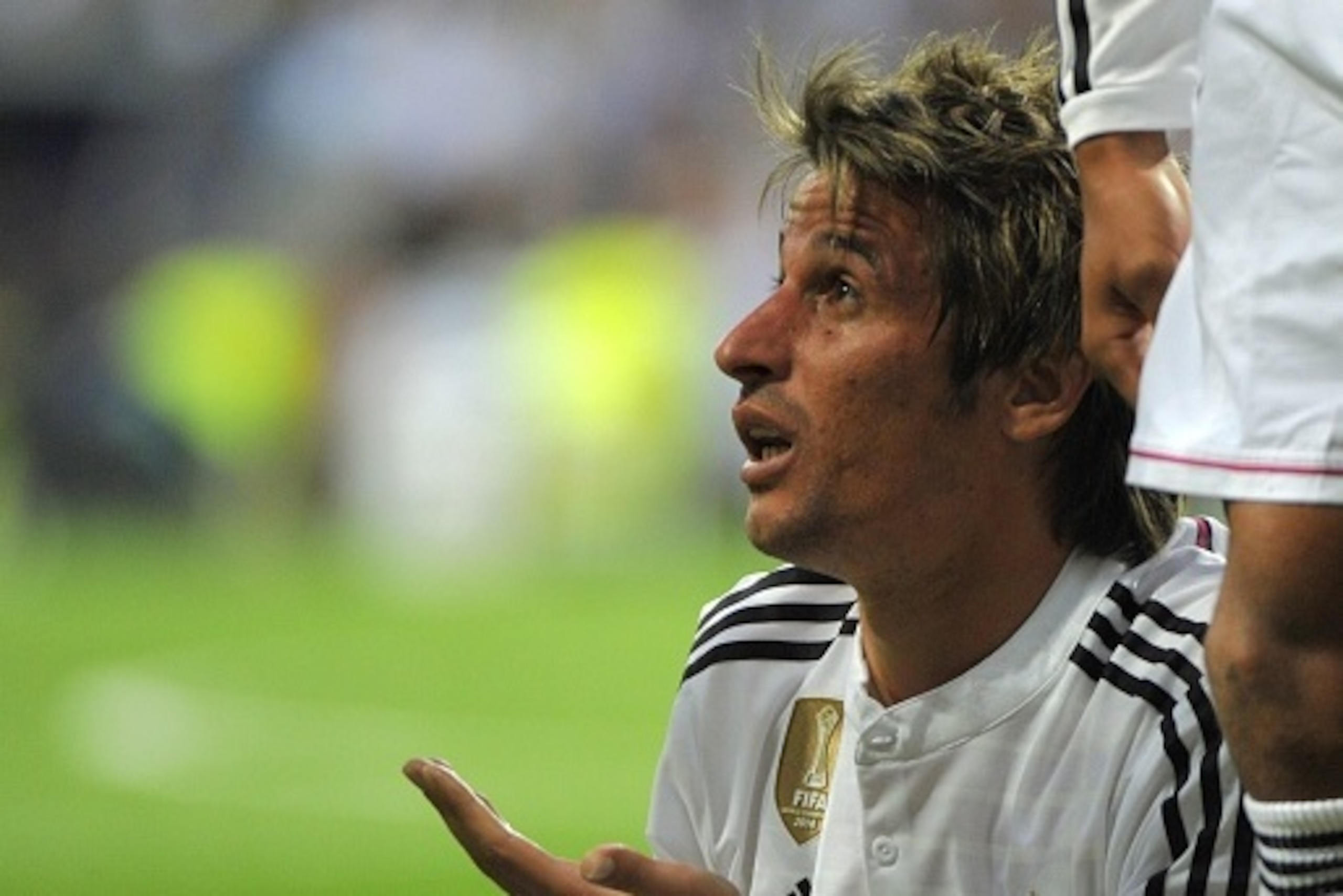Real Madrid's portuguese defender Fabio Coentrao gestures during the UEFA Champions League quarter-finals second leg football match Real Madrid CF vs Club Atletico de Madrid at the Santiago Bernabeu stadium in Madrid on April 22, 2015.      AFP PHOTO / CU