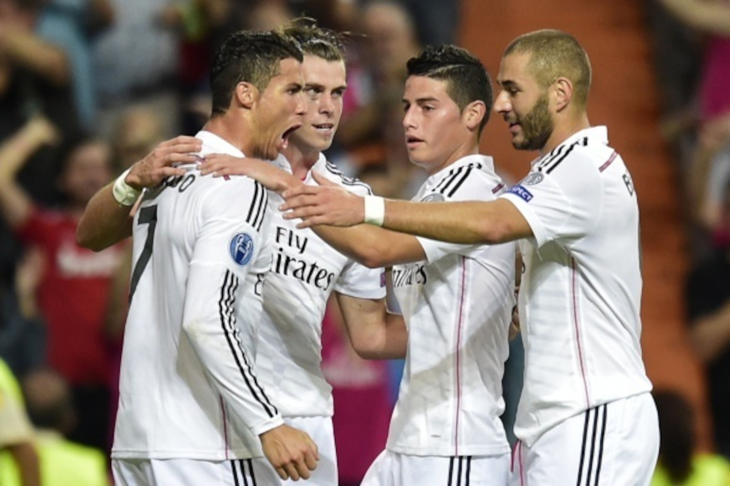 Real Madrid's Portuguese forward Cristiano Ronaldo (L), Real Madrid's Welsh forward Gareth Bale (C), Real Madrid's French forward Karim Benzema (R)and Real Madrid's Colombian midfielder James Rodriguez celebrate after scoring their third goal during the U