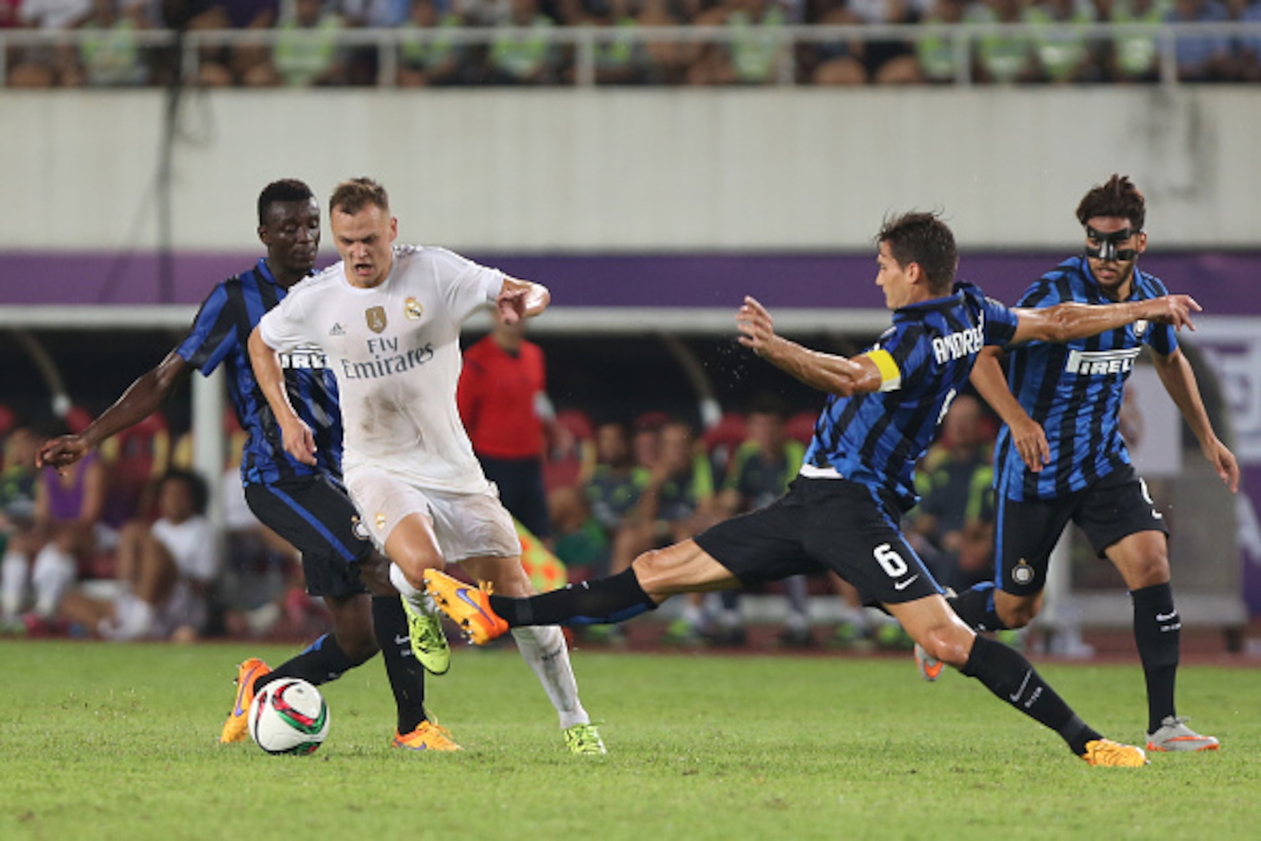 GUANGZHOU, CHINA - JULY 27: Denis Cheryshev of Real Madrid competes with Andreolli Marco of FC Internazionale during the match of International Champions Cup China 2015 between Real Madrid and FC Internazionale at Tianhe Stadium on July 27, 2015 in Guangz