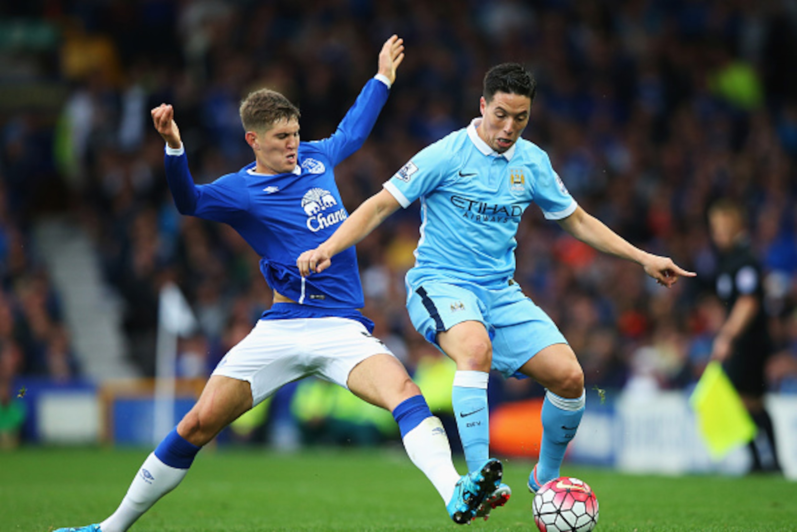 LIVERPOOL, ENGLAND - AUGUST 23:  John Stones of Everton challenges Samir Nasri of Manchester City during the Barclays Premier League match between Everton and Manchester City at Goodison Park on August 23, 2015 in Liverpool, England.  (Photo by Alex Lives