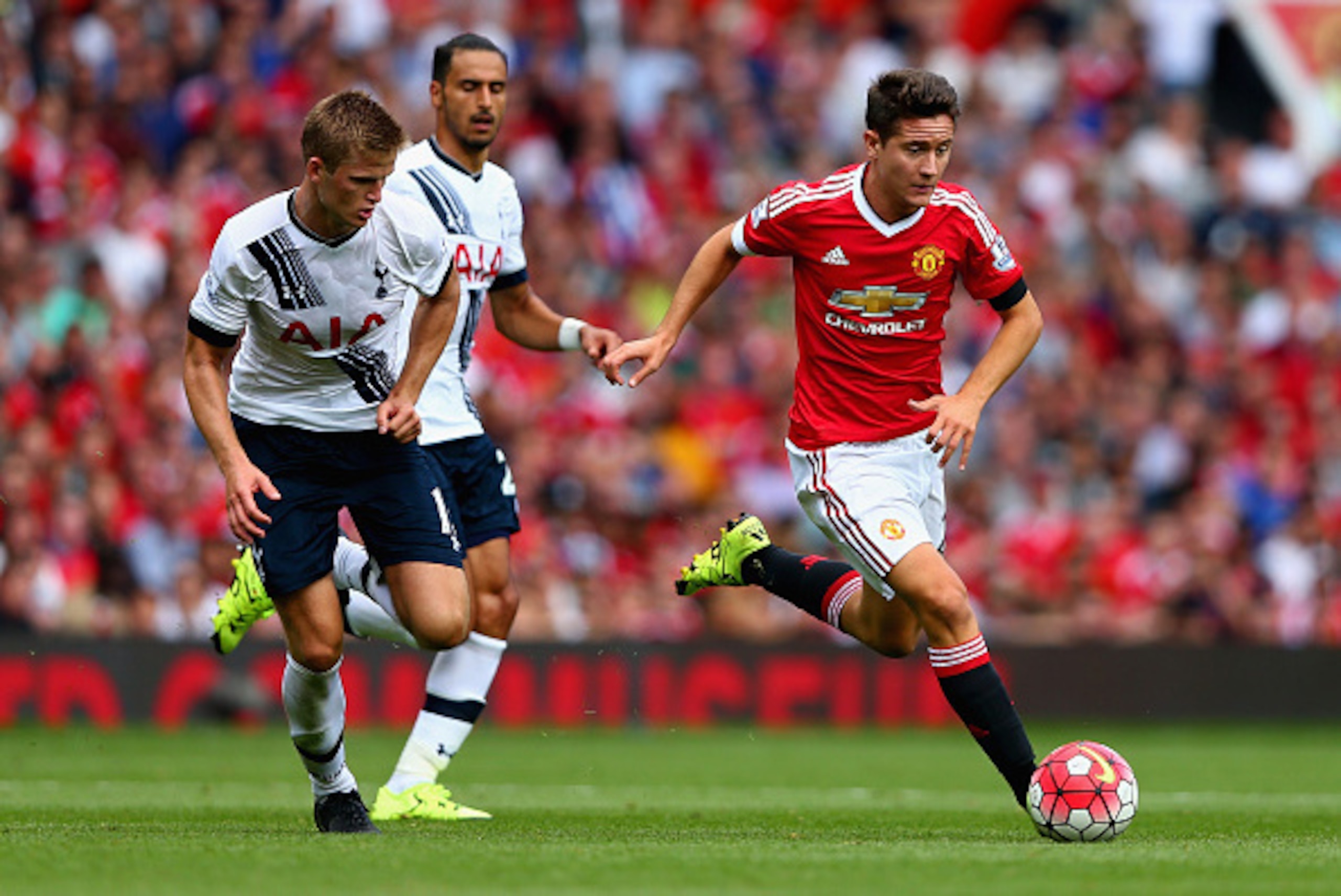 MANCHESTER, ENGLAND - AUGUST 08:  Ander Herrera of Manchester United and Eric Dier of Tottenham Hotspur compete for the ball during the Barclays Premier League match between Manchester United and Tottenham Hotspur at Old Trafford on August 8, 2015 in Manc