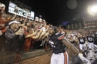 Aug 30, 2014; Auburn, AL, USA;  Auburn Tigers lineman Avery Young celebrates with students after the Auburn Tigers beat the Arkansas Razorbacks 45-21 at Jordan Hare Stadium.   Mandatory Credit: John Reed-USA TODAY Sports