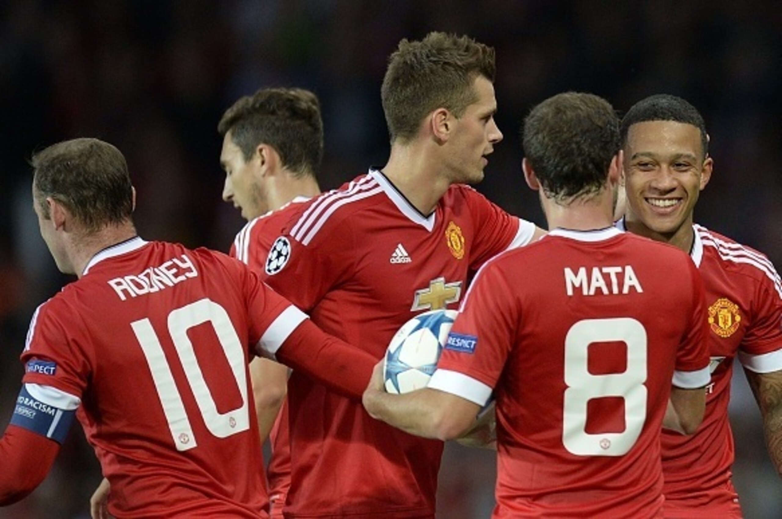 Manchester United's Dutch midfielder Memphis Depay (R) is congratulated after scoring his team's second goal during the UEFA Champions League play off football match between Manchester United and Club Brugge at Old Trafford in Manchester, north west Engla