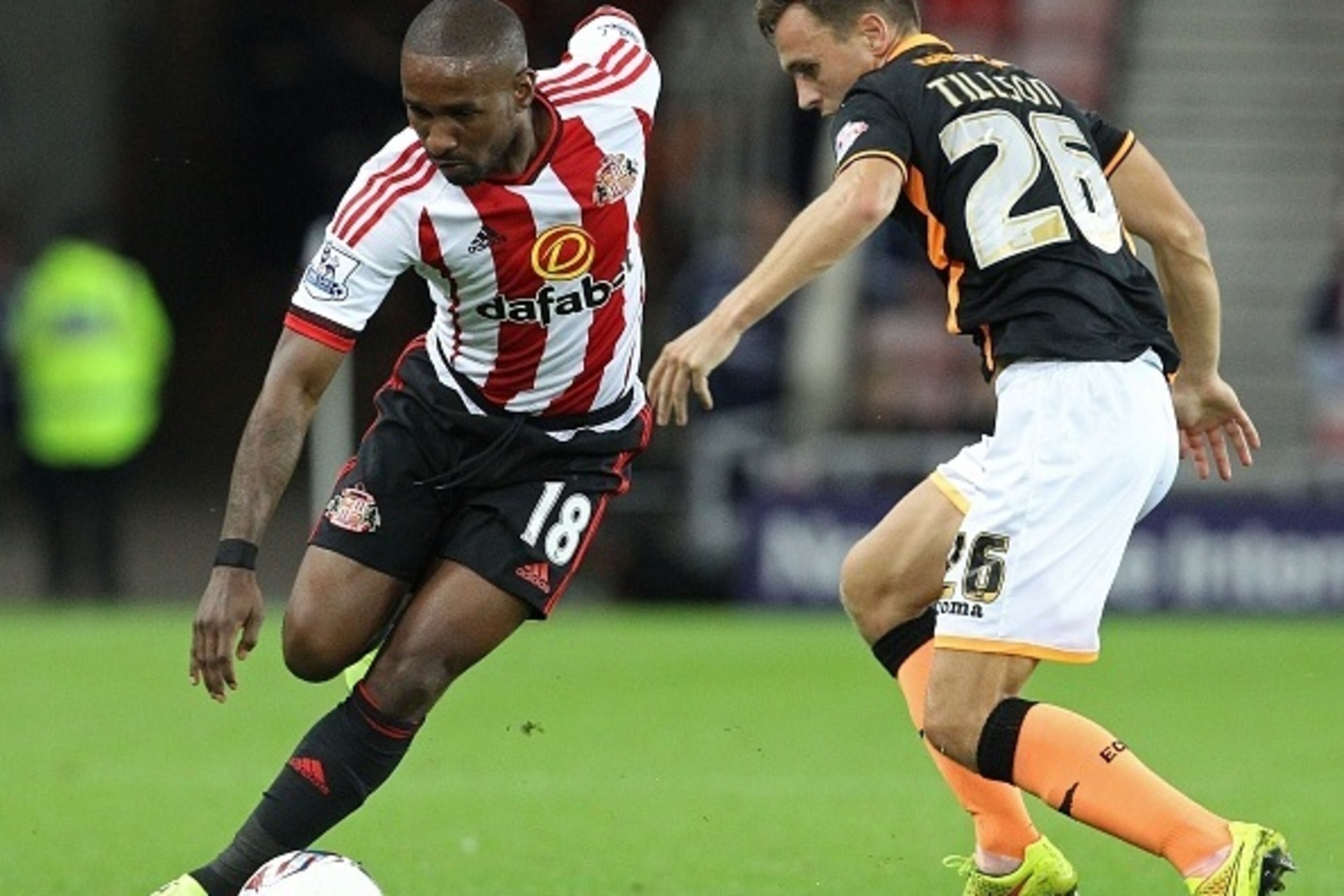 Sunderland's English striker Jermain Defoe (L) vies with Exeter City's English defender Jordan Tillson (R) during the English League Cup second round football match between between Sunderland and Exeter City at the Stadium of Light in Sunderland, north ea
