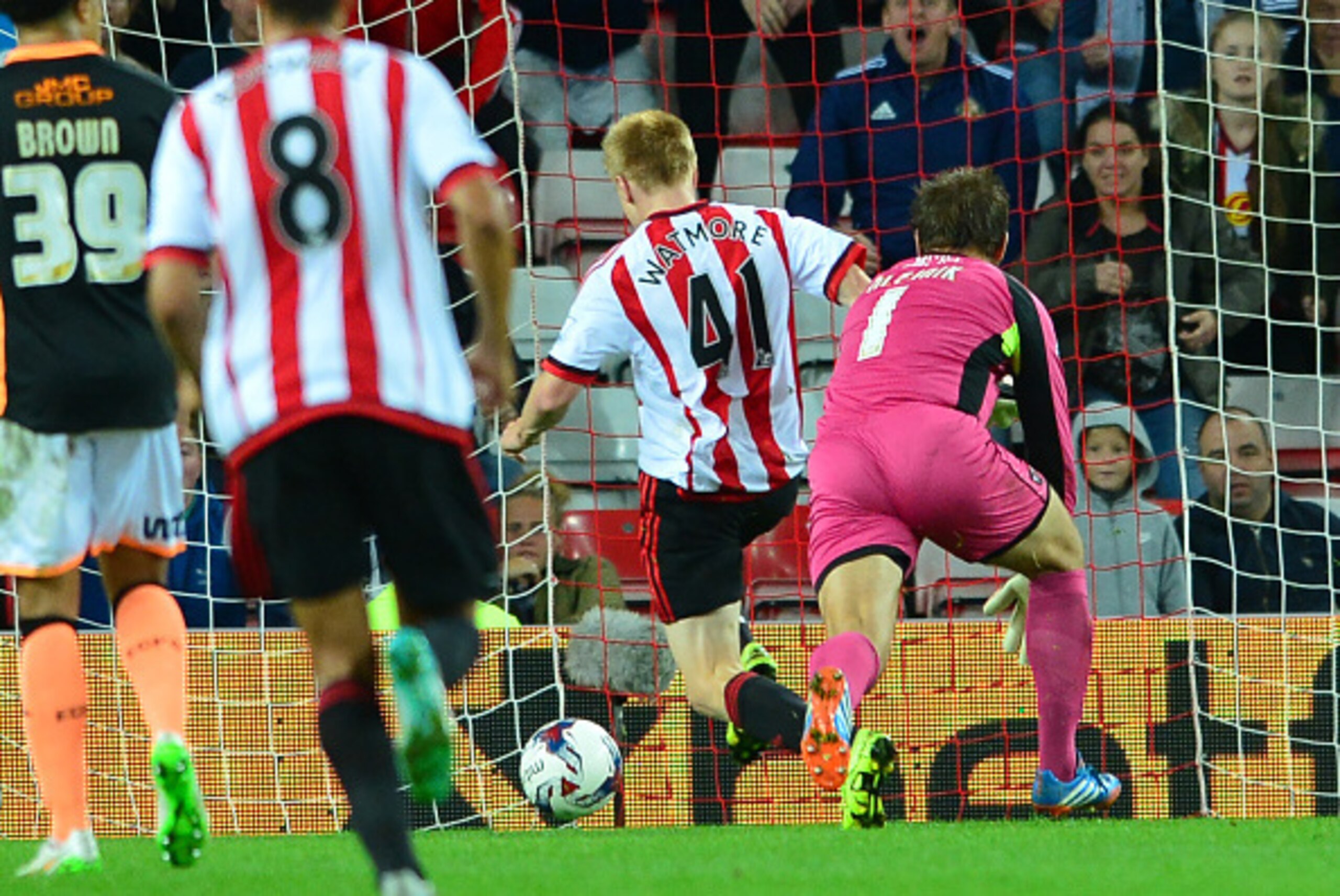 SUNDERLAND, ENGLAND - AUGUST 25 : Duncan Watmore of Sunderland scores their fifth goal in the second half past Exeter goalkeeper Bobby Oleynik during the Capital One Cup Second Round match between Sunderland and Exeter City at Stadium of Light on August 2