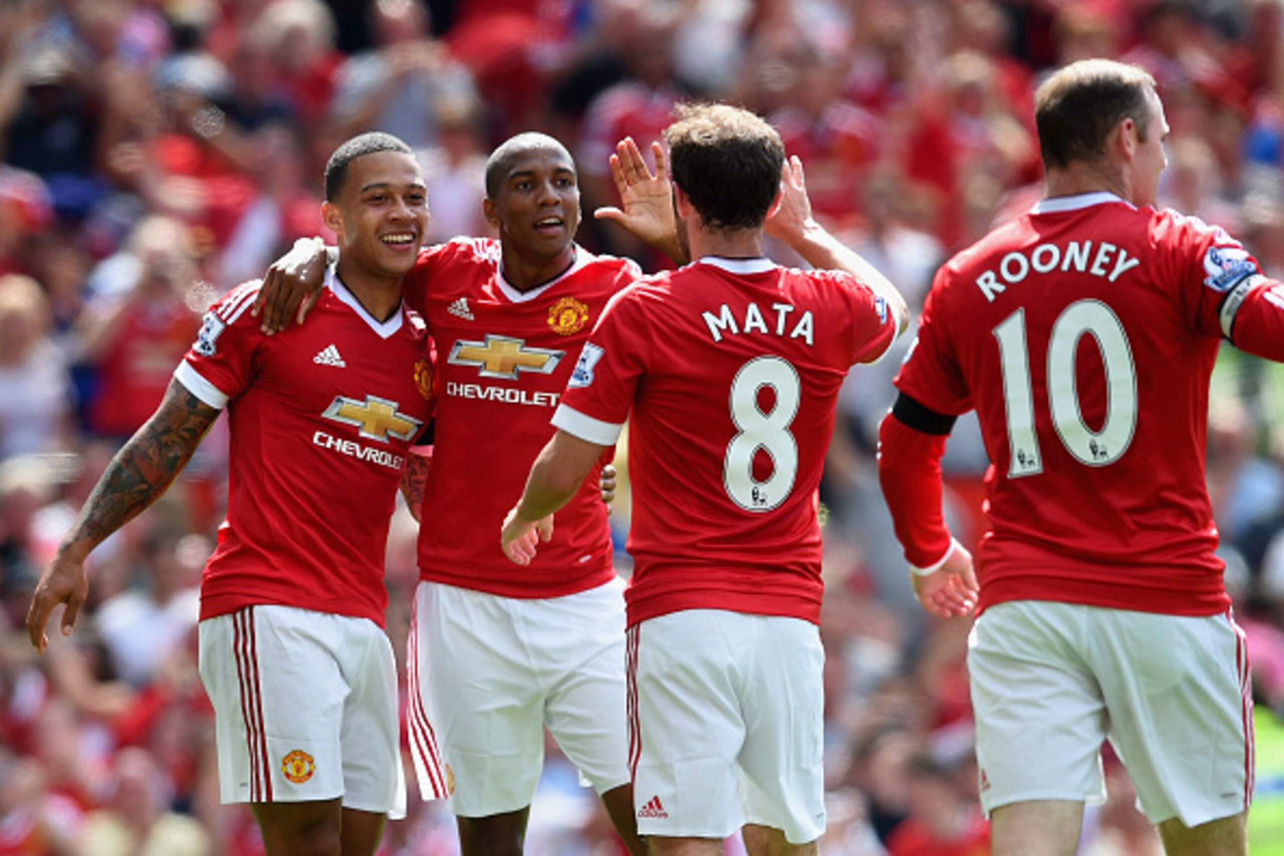 MANCHESTER, ENGLAND - AUGUST 08: (L to R) Memphis Depay, Ashley Young, Juan Mata and Wayne Rooney of Manchester United celebrate their team's first goal during the Barclays Premier League match between Manchester United and Tottenham Hotspur at Old Traffo