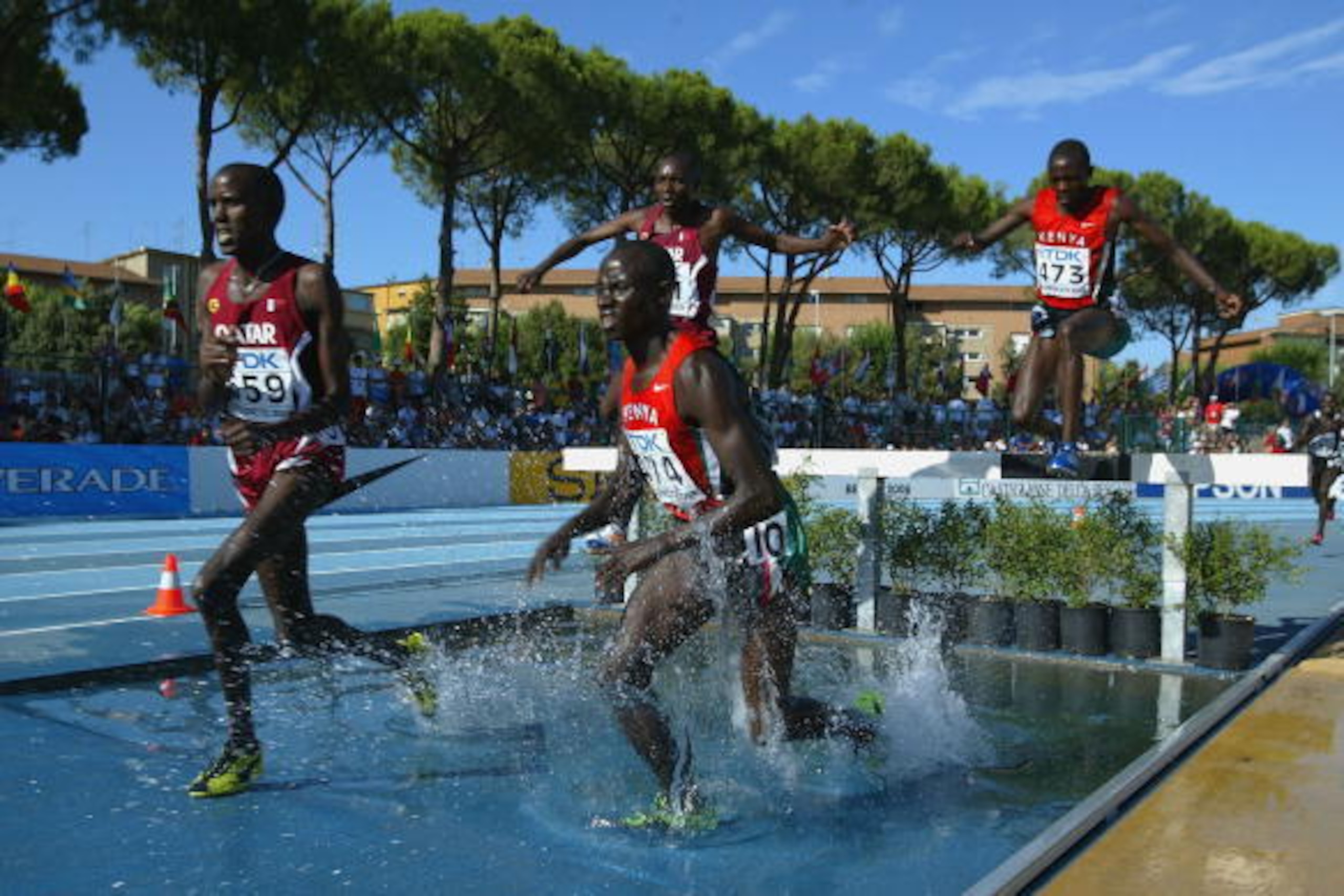 GROSSETO, ITALY - JULY 17:  Ronald Kipchumba Rutto (#474) of Kenya on his way to winning the Men's 3000m Steeplechase final at the IAAF World Juniors Championships at the Olimpico Stadium on July 17, 2004, in Grosseto, Italy. (Photo by Paul Gilham/Getty I