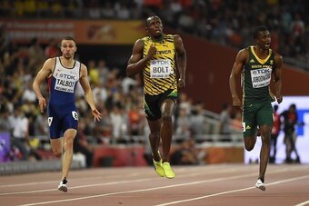 (L-R) Britain's Daniel Talbot, Jamaica's Usain Bolt and South Africa's Anaso Jobodwana compete in a semi-final heat of the men's 200 metres athletics event at the 2015 IAAF World Championships at the 'Bird's Nest' National Stadium in Beijing on August 26,