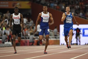 (L-R) Canada's Brendon Rodney, Britain's Zharnel Hughes and Greece's Likourgos-Stefanos Tsakonas compete in a semi-final heat of the men's 200 metres athletics event at the 2015 IAAF World Championships at the 'Bird's Nest' National Stadium in Beijing on 