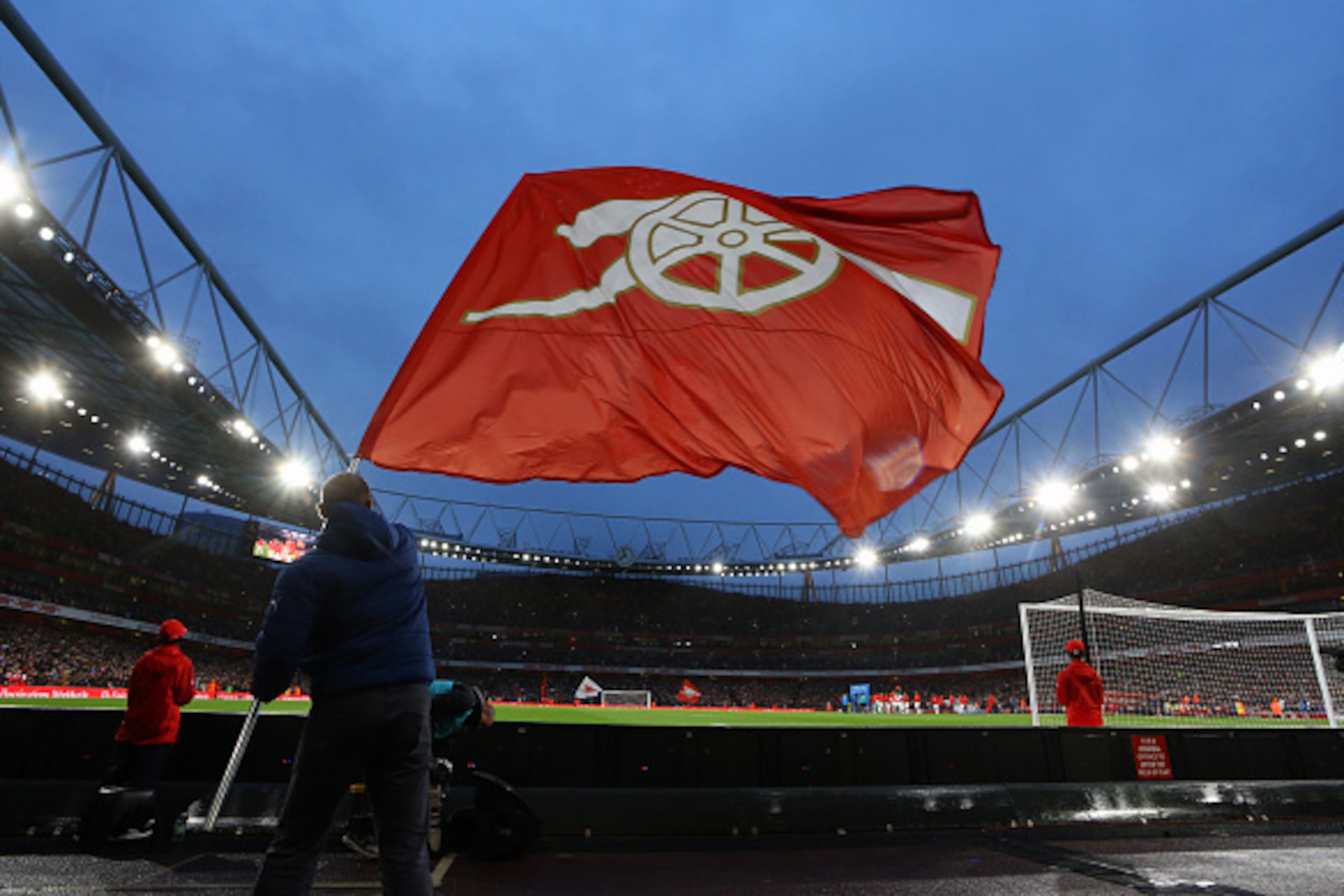 LONDON, ENGLAND - AUGUST 24:  An Arsenal flag is waved before the Barclays Premier League match between Arsenal and Liverpool at the Emirates Stadium on August 24, 2015 in London, United Kingdom.  (Photo by Catherine Ivill - AMA/Getty Images)