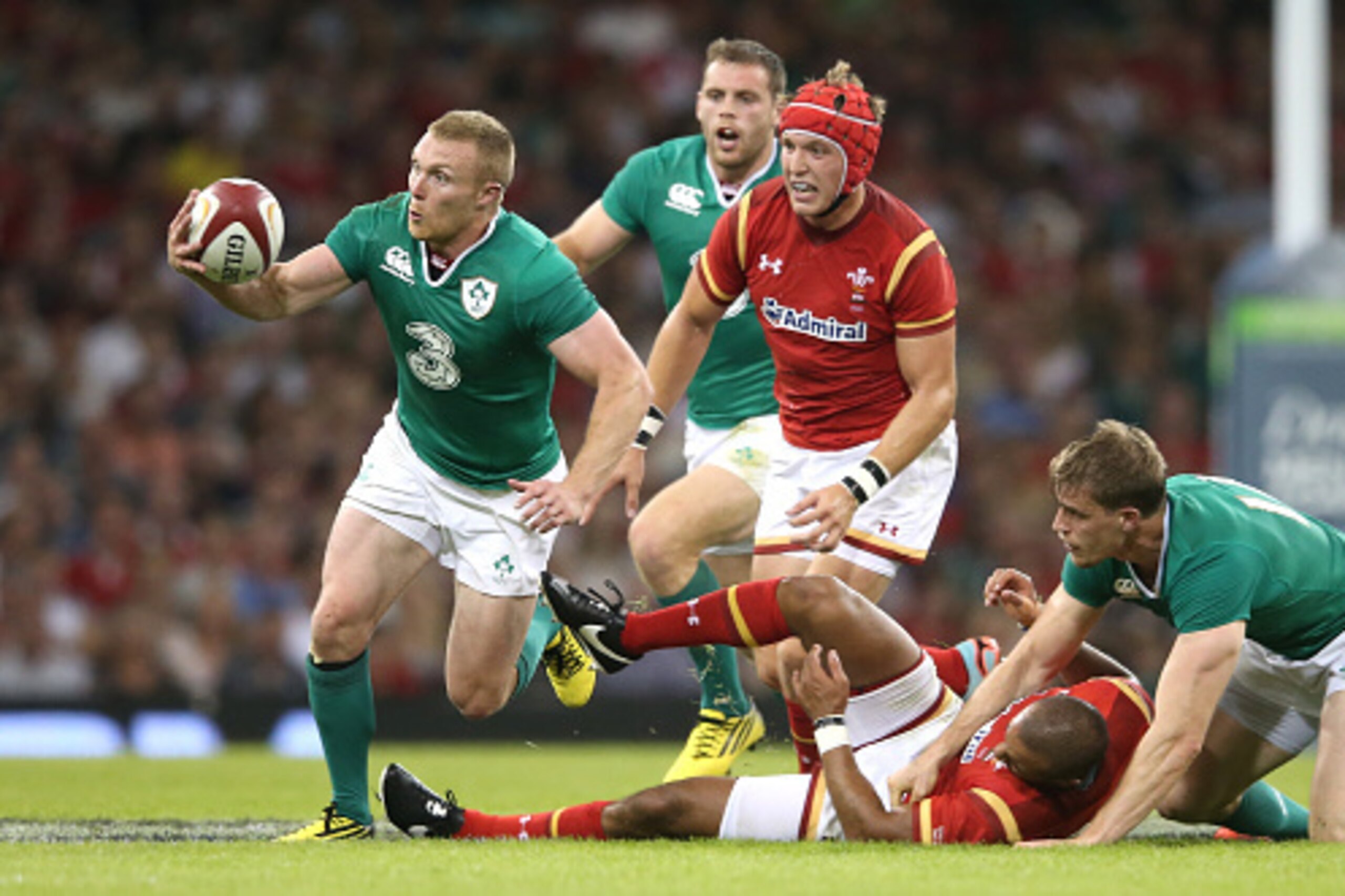 CARDIFF, WALES - AUGUST 08:  Keith Earls (L) of Ireland catches the ball to score a try after Eli Walker of Wales is tackled by Andrew Trimble during the International match between Wales and Ireland at the Millennium Stadium on August 8, 2015 in Cardiff,