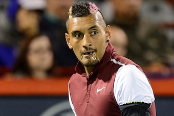 MONTREAL, ON - AUGUST 12:  Nick Kyrgios of Australia looks on as he bites onto his chain against Stan Wawrinka of Switzerland during day three of the Rogers Cup at Uniprix Stadium on August 12, 2015 in Montreal, Quebec, Canada.  (Photo by Minas Panagiotak