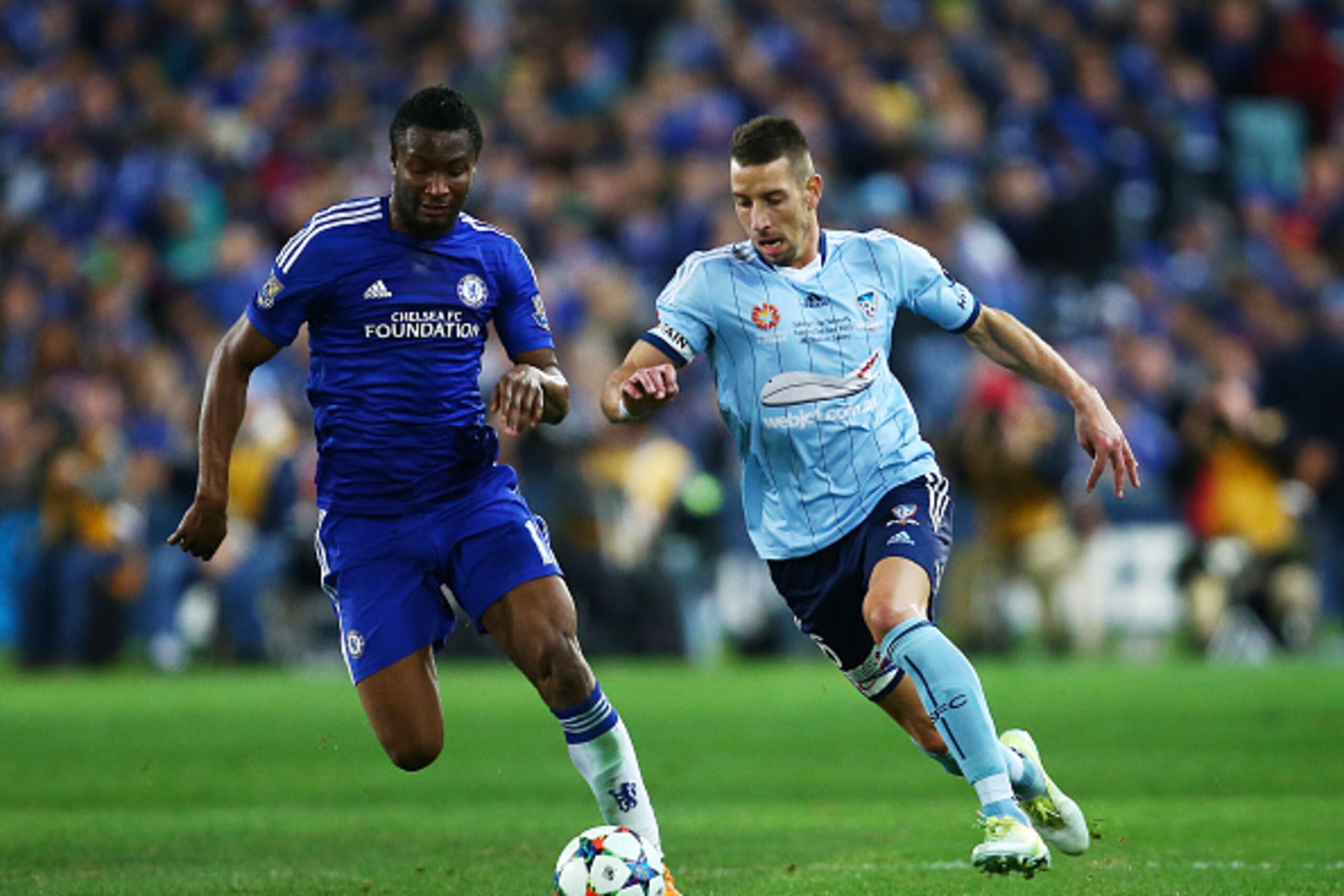 SYDNEY, AUSTRALIA - JUNE 02:  Nikola Petkovic of Sydney FC and John Obi Mikel of Chelsea compete for the ball and run past a paper plane on the pitch thrown by a fan during the international friendly match between Sydney FC and Chelsea FC at ANZ Stadium o
