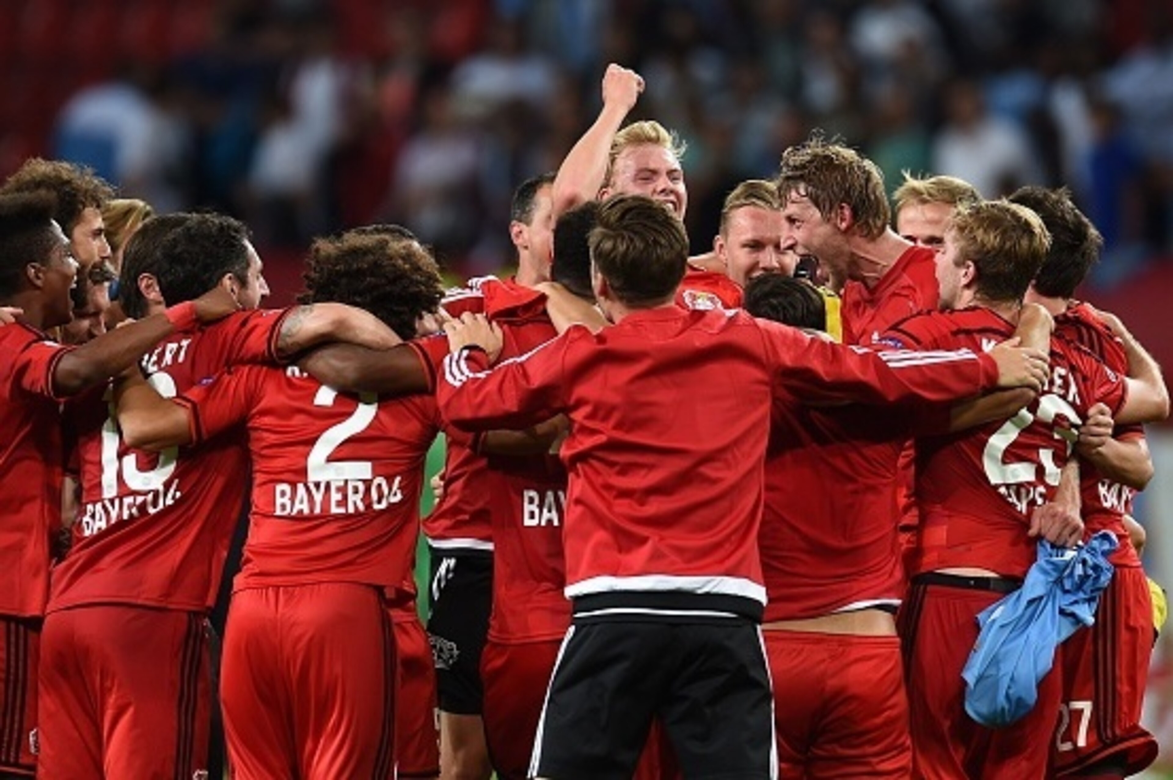 Leverkusen's players celebrate after the UEFA Champions League second leg playoff football match between Bayer Leverkusen and SS Lazio in Leverkusen, western Germany, on August 26, 2015.  Leverkusen wins 3-0. AFP PHOTO / PATRIK STOLLARZ        (Photo cred