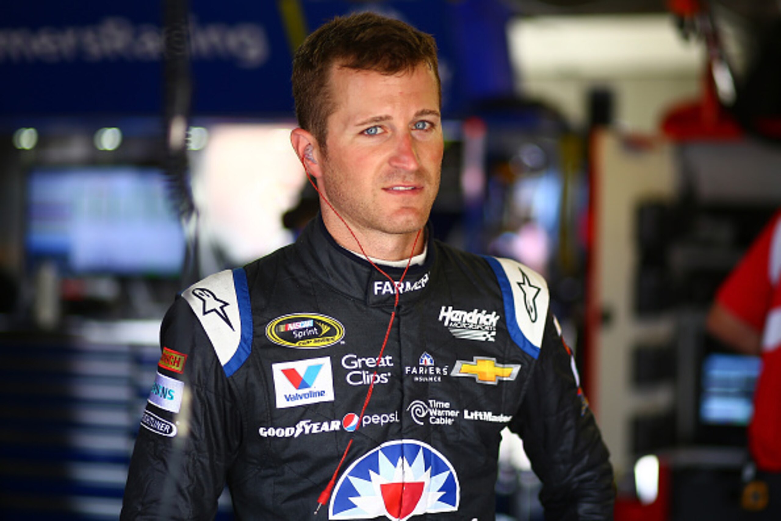 BROOKLYN, MI - AUGUST 14: Kasey Kahne, driver of the #5 Farmers Insurance Chevrolet, stands in the garage area during practice for the NASCAR Sprint Cup Series Pure Michigan 400 at Michigan International Speedway on August 14, 2015 in Brooklyn, Michigan. BROOKLYN, MI - AUGUST 14: Kasey Kahne, driver of the #5 Farmers Insurance Chevrolet, stands in the garage area during practice for the NASCAR Sprint Cup Series Pure Michigan 400 at Michigan International Speedway on August 14, 2015 in Brooklyn, Michigan.