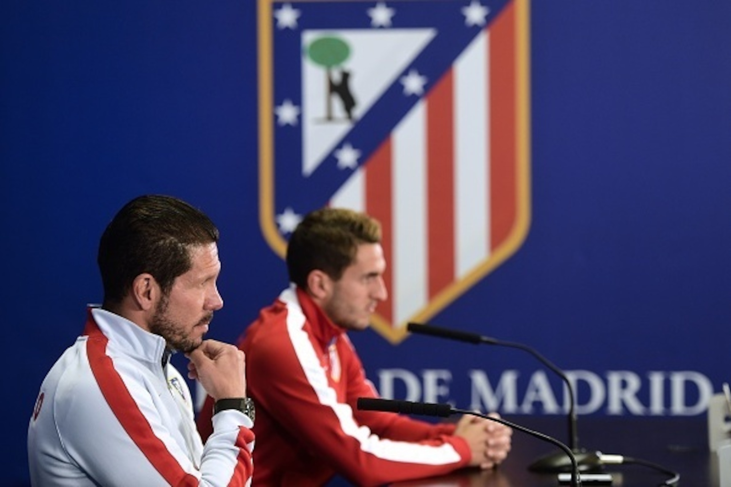 Atletico Madrid's Argentinian coach Diego Simeone (L) and Atletico Madrid's midfielder Koke attend a press conference at the Vicente Calderon stadium in Madrid on April 21, 2015 on the eve of the Champions League football match Atletico Madrid vs Real Mad