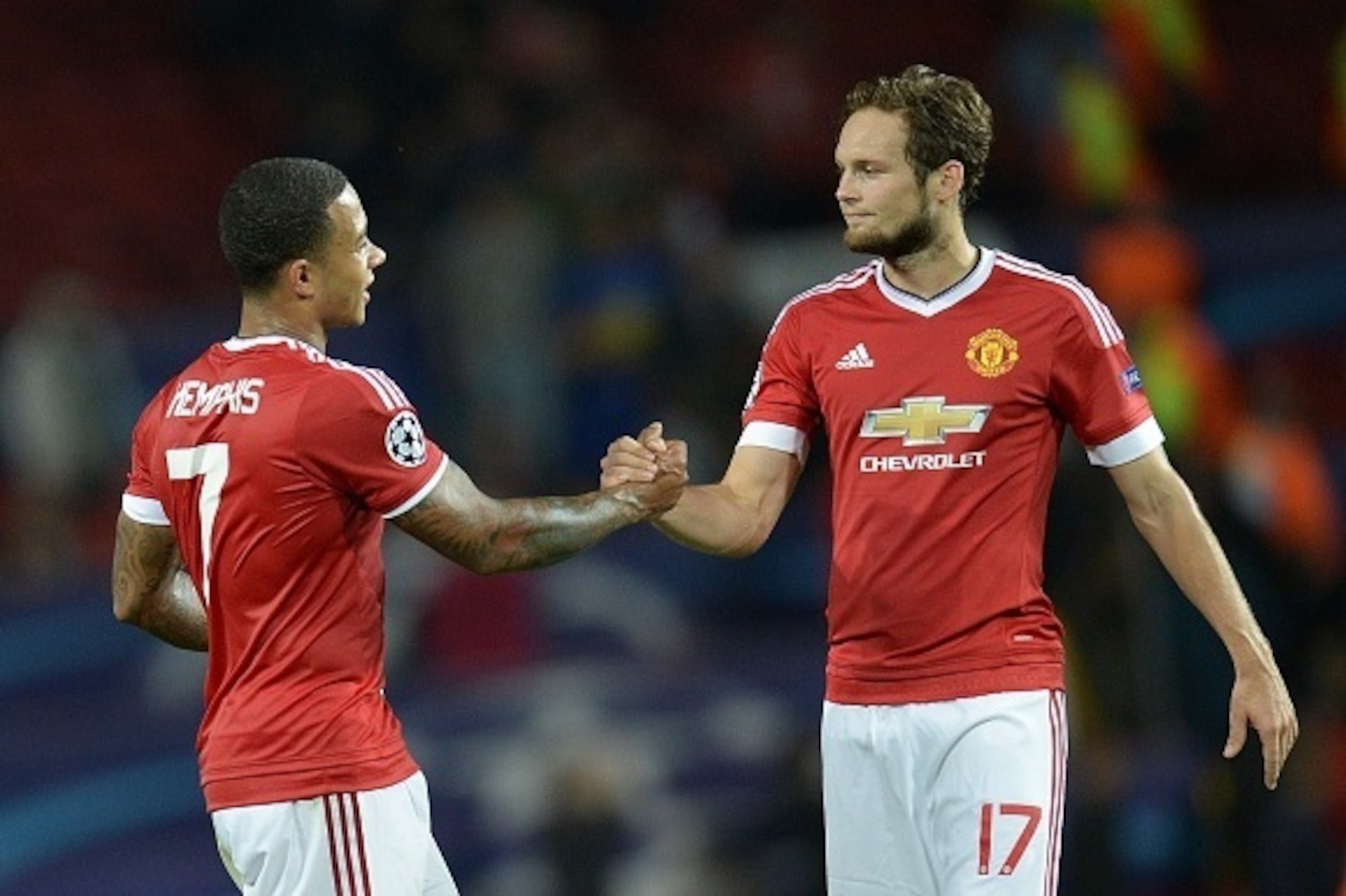 Manchester United's Dutch midfielder Memphis Depay (L) and Manchester United's Dutch midfielder Daley Blind are pictured after winning 3-1 during the UEFA Champions League play off football match between Manchester United and Club Brugge at Old Trafford i