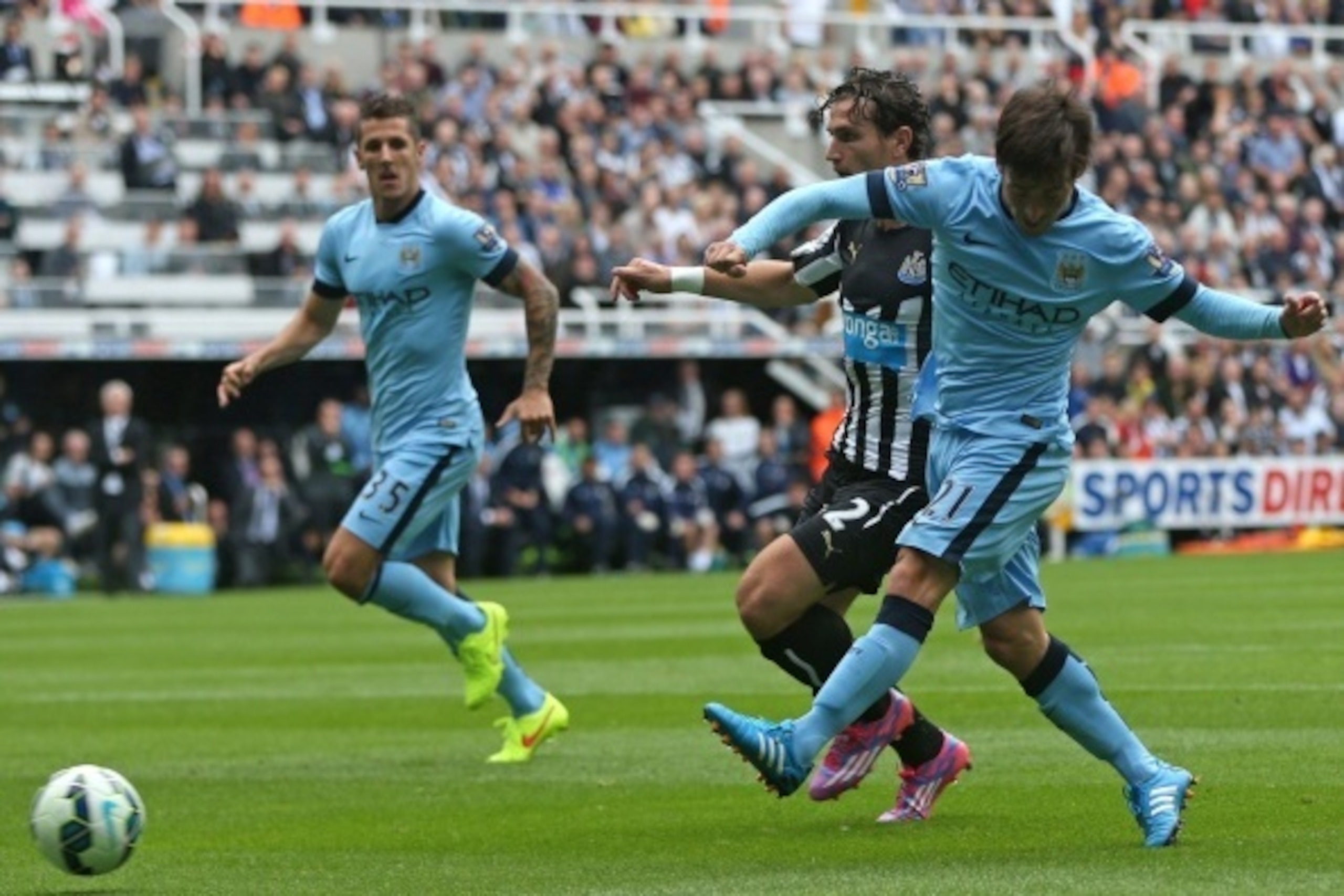 Manchester City's Spanish midfielder David Silva (R) shoots under pressure from Newcastle United's Dutch defender Daryl Janmaat (2nd R) to score the opening goal of the English Premier League football match between Newcastle United and Manchester City at Manchester City's Spanish midfielder David Silva (R) shoots under pressure from Newcastle United's Dutch defender Daryl Janmaat (2nd R) to score the opening goal of the English Premier League football match between Newcastle United and Manchester City at