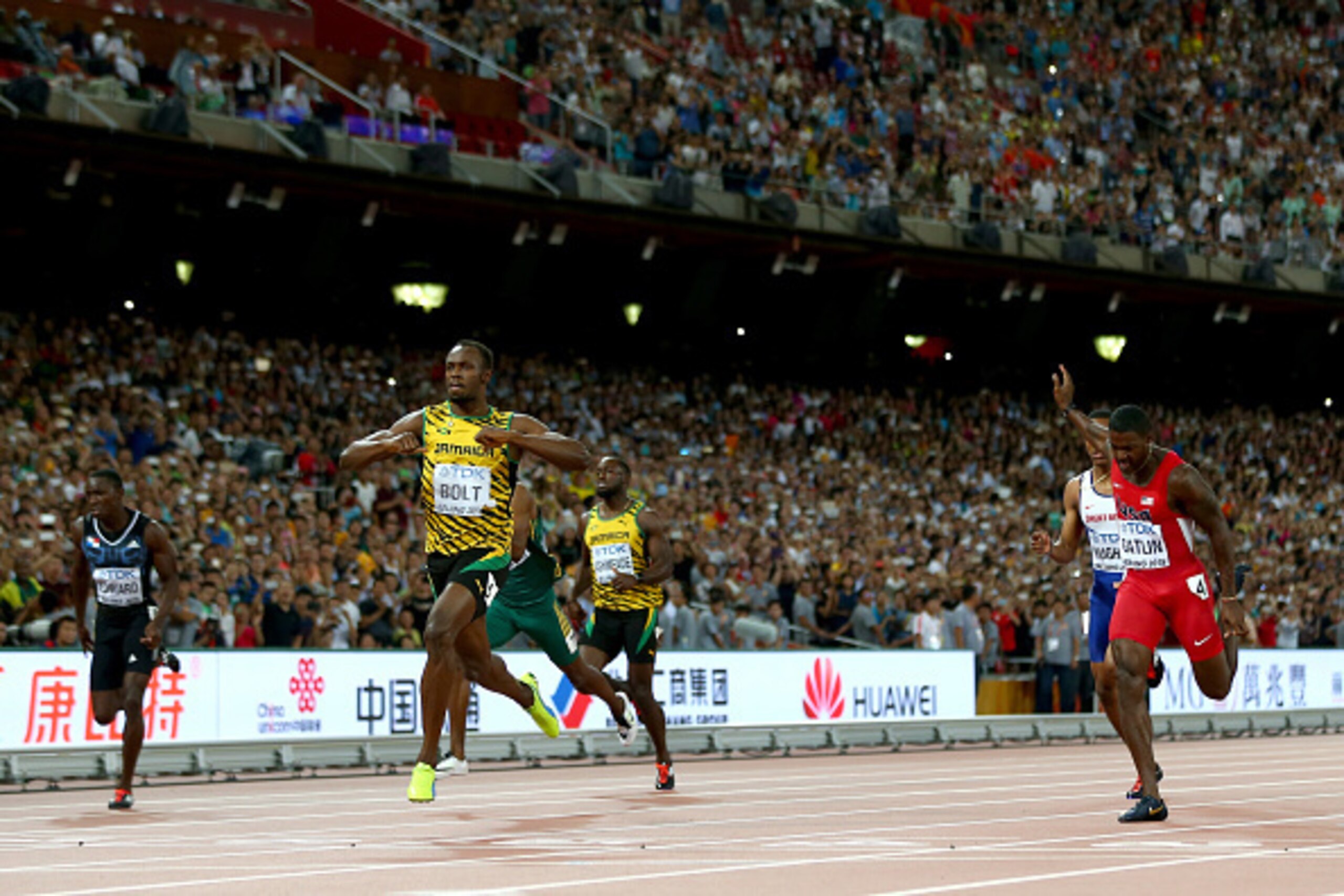 BEIJING, CHINA - AUGUST 27:  Usain Bolt of Jamaica crosses the finish line to win gold ahead of Justin Gatlin of the United States (R) in the Men's 200 metres final during day six of the 15th IAAF World Athletics Championships Beijing 2015 at Beijing Nati