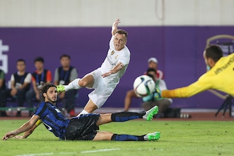 GUANGZHOU, CHINA - JULY 27: Denis Cheryshev of Real Madrid attempts a goal against Ranocchia Andrea of FC Internazionale during the match of International Champions Cup match between Real Madrid and FC Internazionale at Tianhe Stadium on July 27, 2015 in 