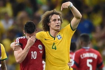Brazil's defender David Luiz (R) gestures as he consoles Colombia's midfielder James Rodriguez at the end of the quarter-final football match between Brazil and Colombia at the Castelao Stadium in Fortaleza during the 2014 FIFA World Cup on July 4, 2014. 