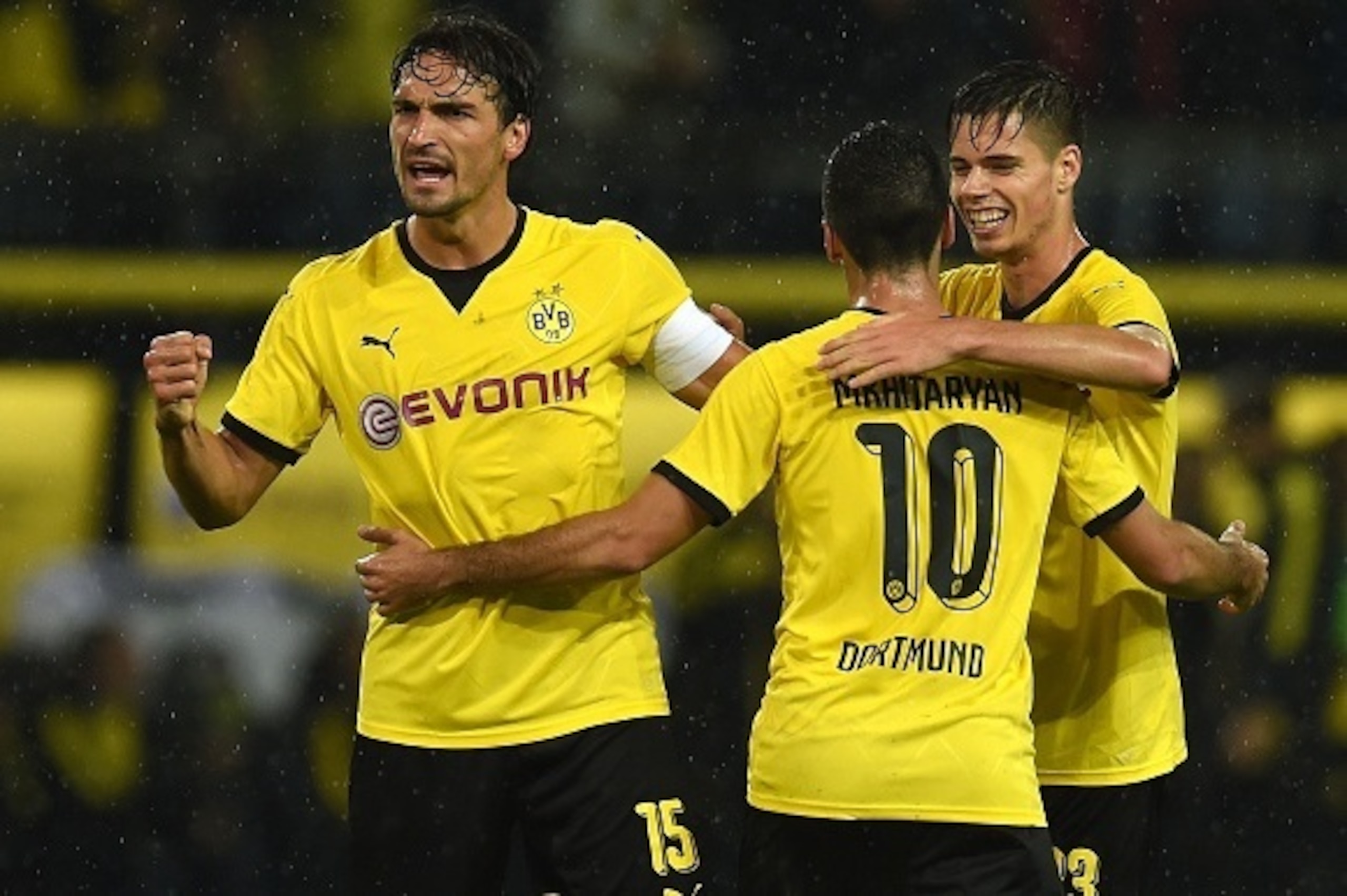 Dortmund's Armenian midfielder Henrikh Mkhitaryan , Dortmund's defender Mats Hummels and Dortmund's midfielder Julian Weigl celebrate during the UEFA Europa League second-leg play-off match between Borussia Dortmund and Odds BK in Dortmund on August 28, 2