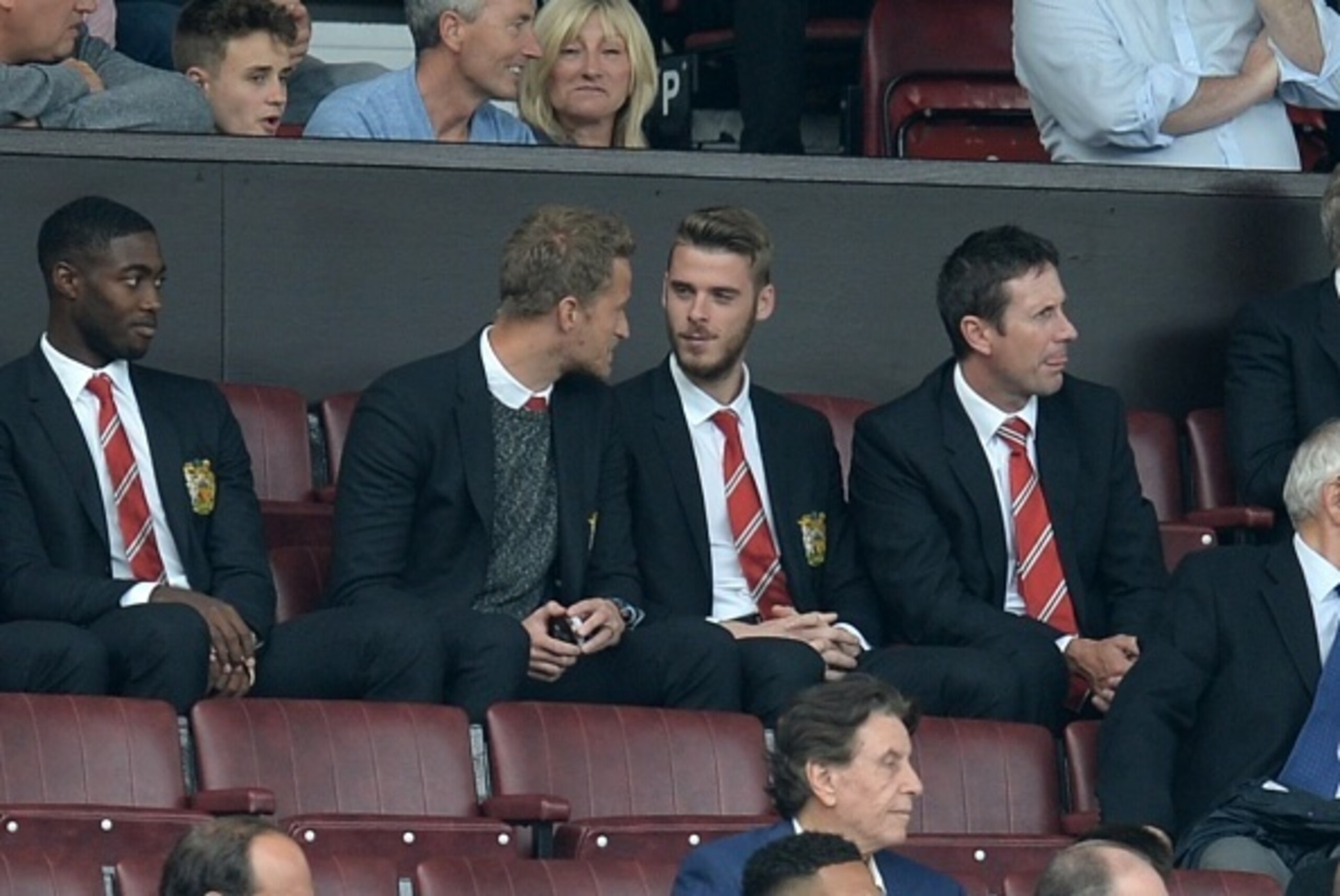 Manchester United's Spanish goalkeeper David de Gea (centre right) sits in the stands ahead of the English Premier League football match between Manchester United and Newcastle United at Old Trafford in Manchester, north west England, on August 22, 2015. 