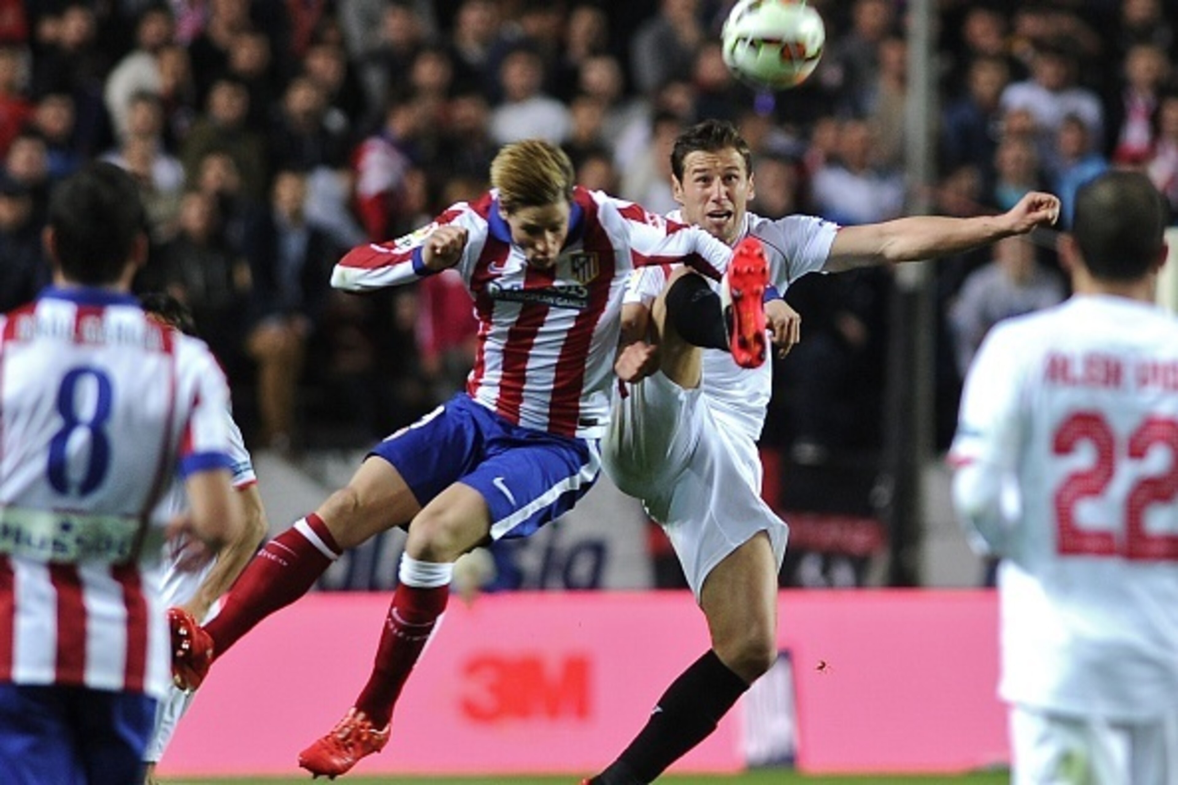 Atletico Madrid's forward Fernando Torres (L) vies with Sevilla's Polish midfielder Grzegorz Krychowiak (R) during the Spanish league football match Sevilla FC vs Club Atletico de Madrid at the Ramon Sanchez Pizjuan stadium in Sevilla on March 1, 2015.   