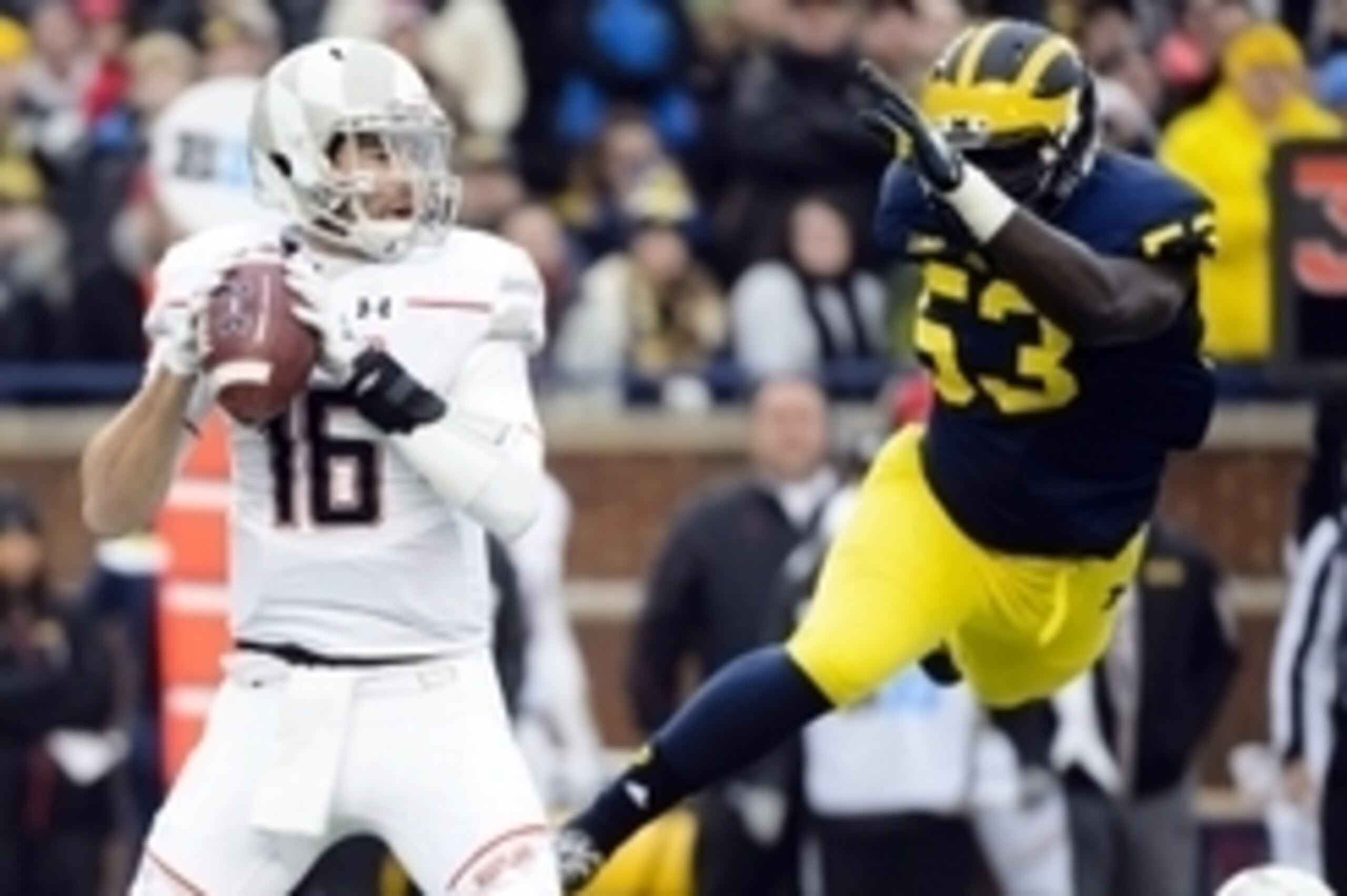 Nov 22, 2014; Ann Arbor, MI, USA; Maryland Terrapins quarterback C.J. Brown (16) is pressured by Michigan Wolverines defensive end Mario Ojemudia (53) in the first quarter at Michigan Stadium. Mandatory Credit: Rick Osentoski-USA TODAY Sports