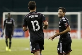 Aug 25, 2015; Washington, DC, USA; D.C. United midfielder Miguel Aguilar (17) celebrates with midfielder/forward Chris Pontius (13) after scoring a goal against Montego Bay F.C. in the first half at RFK Stadium. United won 3-0. Mandatory Credit: Geoff Bur